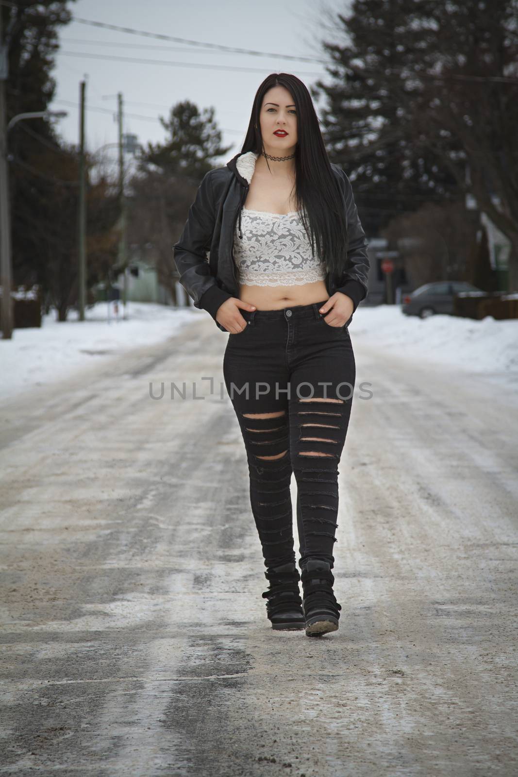 sexy young woman walking in the street in winter