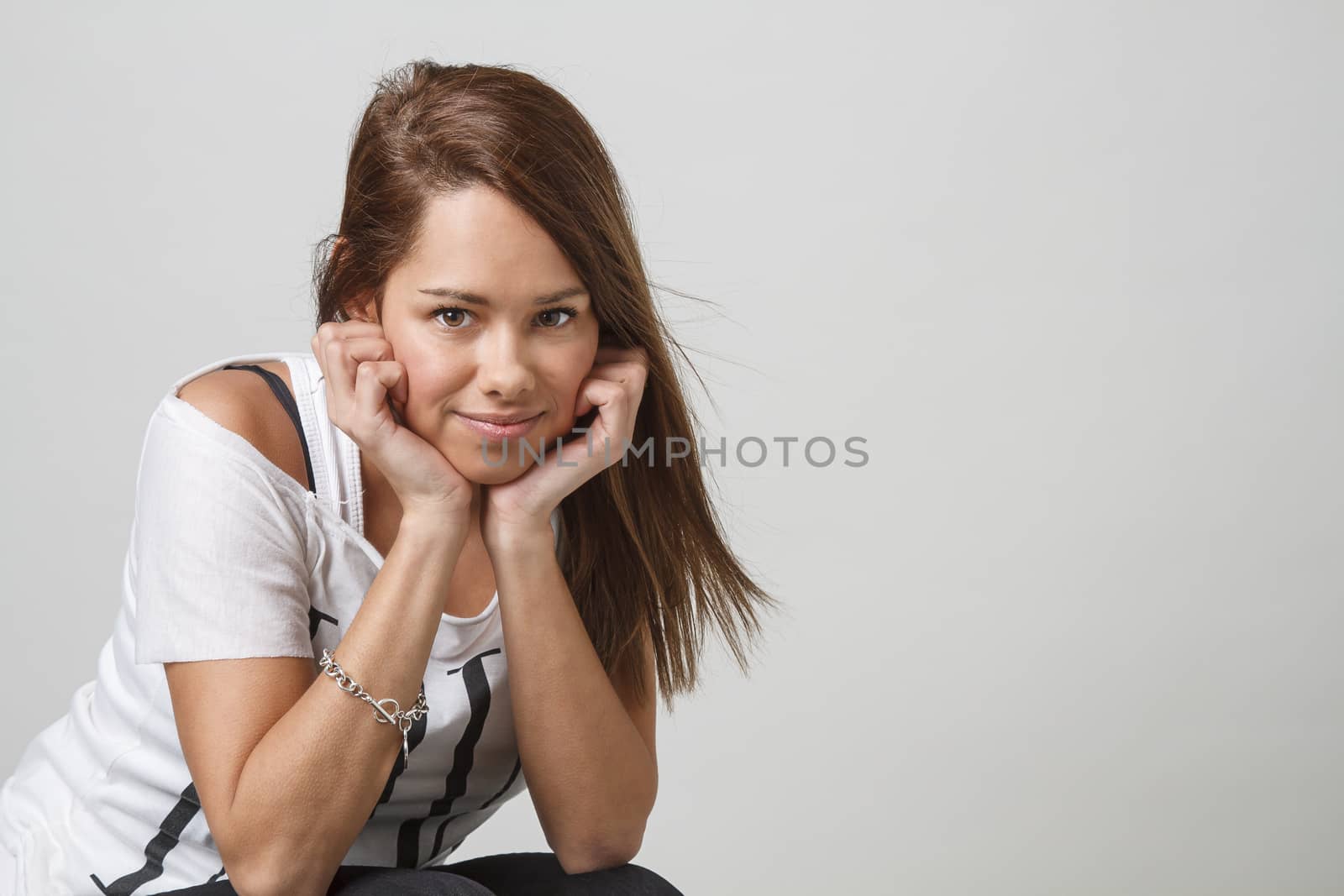 young twenty year old woman, holding her head into her hand