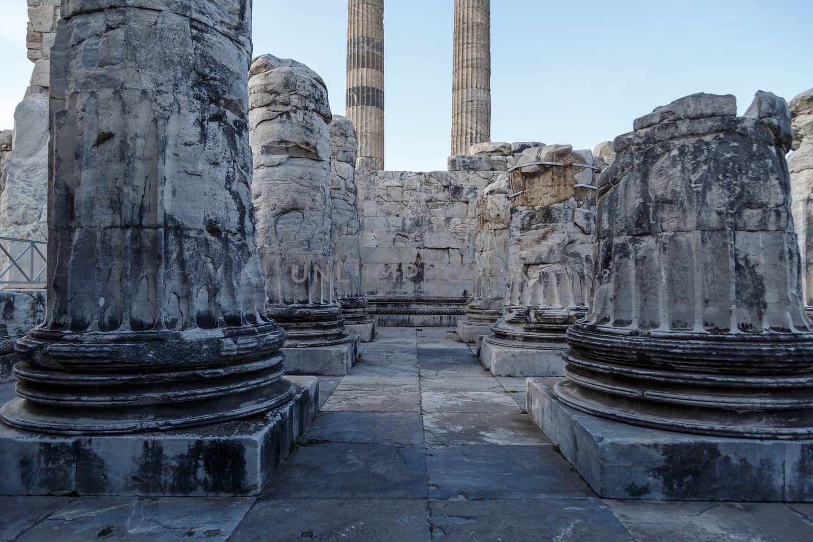 View of Didyma Ancient City in Aydın, Turkey, with granit columns and temple, on blue sky background.
