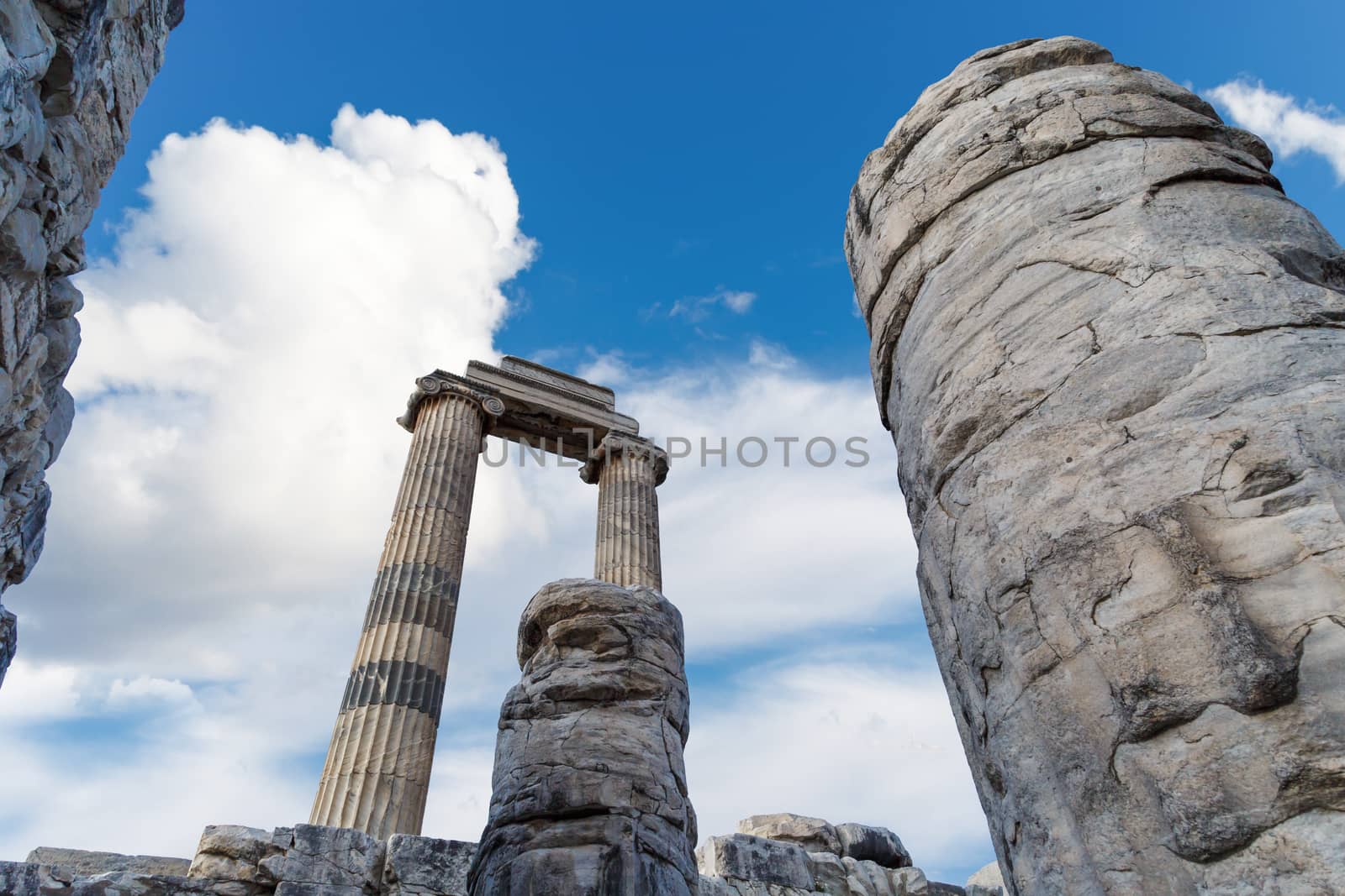 View of Didyma Ancient City in Aydın, Turkey, with granit columns and temple, on blue sky background.