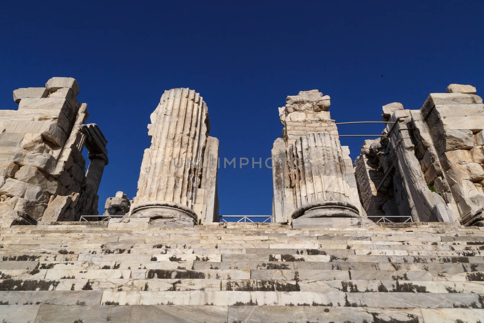 View of Didyma Ancient City in Aydın, Turkey, with granit columns and temple, on blue sky background.