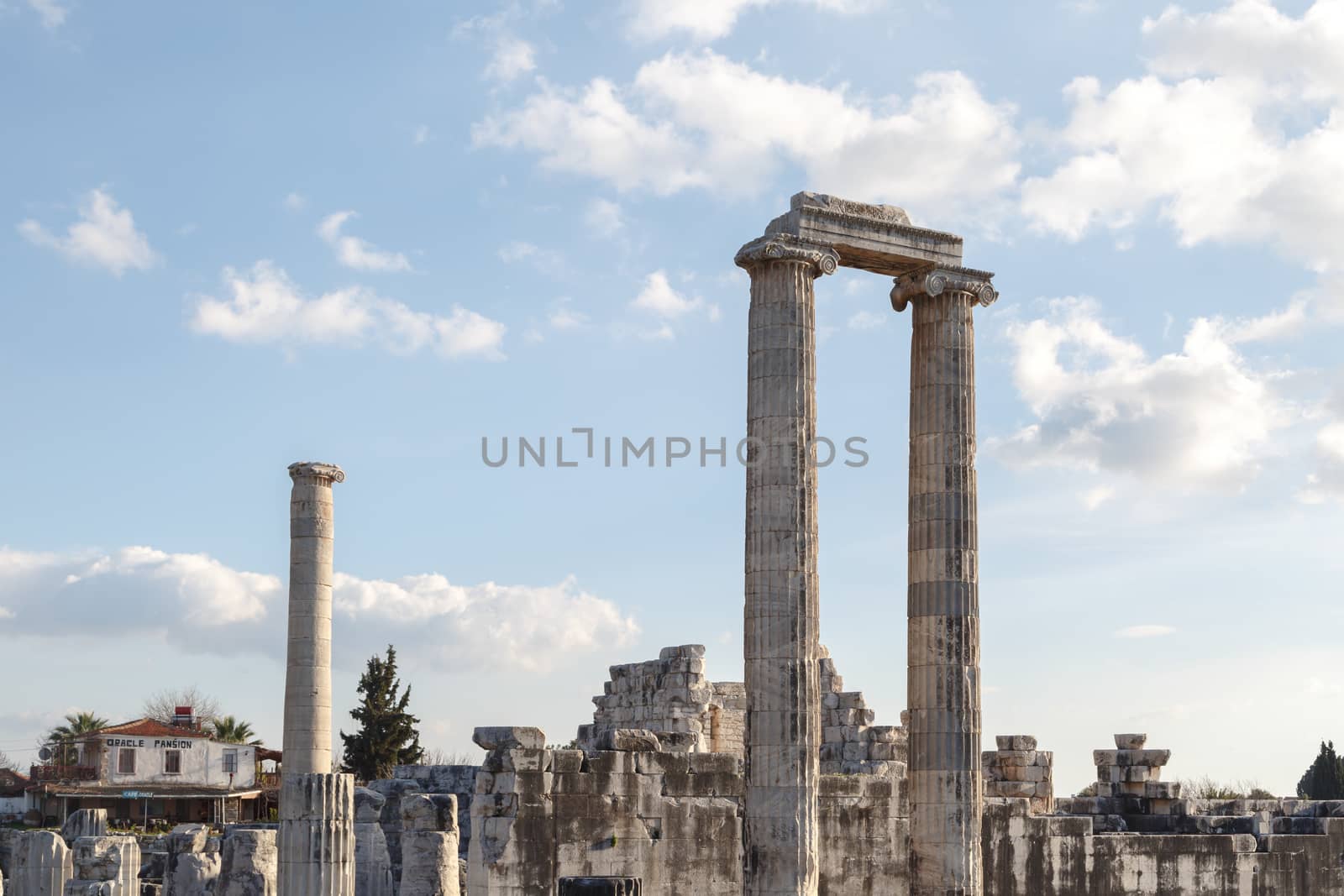 General view of ruins of Apollon Temple in Didyma Ancient City, on cloudy blue sky background.