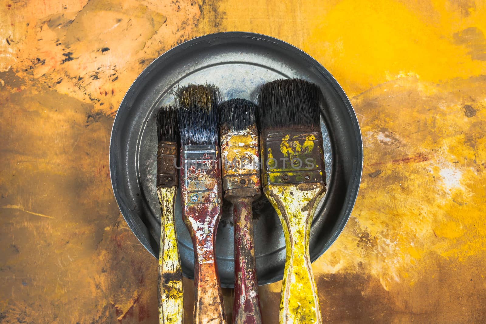 Oil paint brushes on wood painted background by nopparats