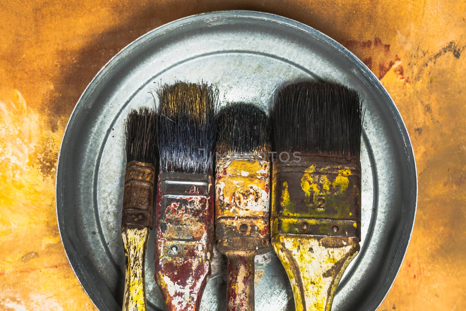 Oil paint brushes on wood painted background by nopparats