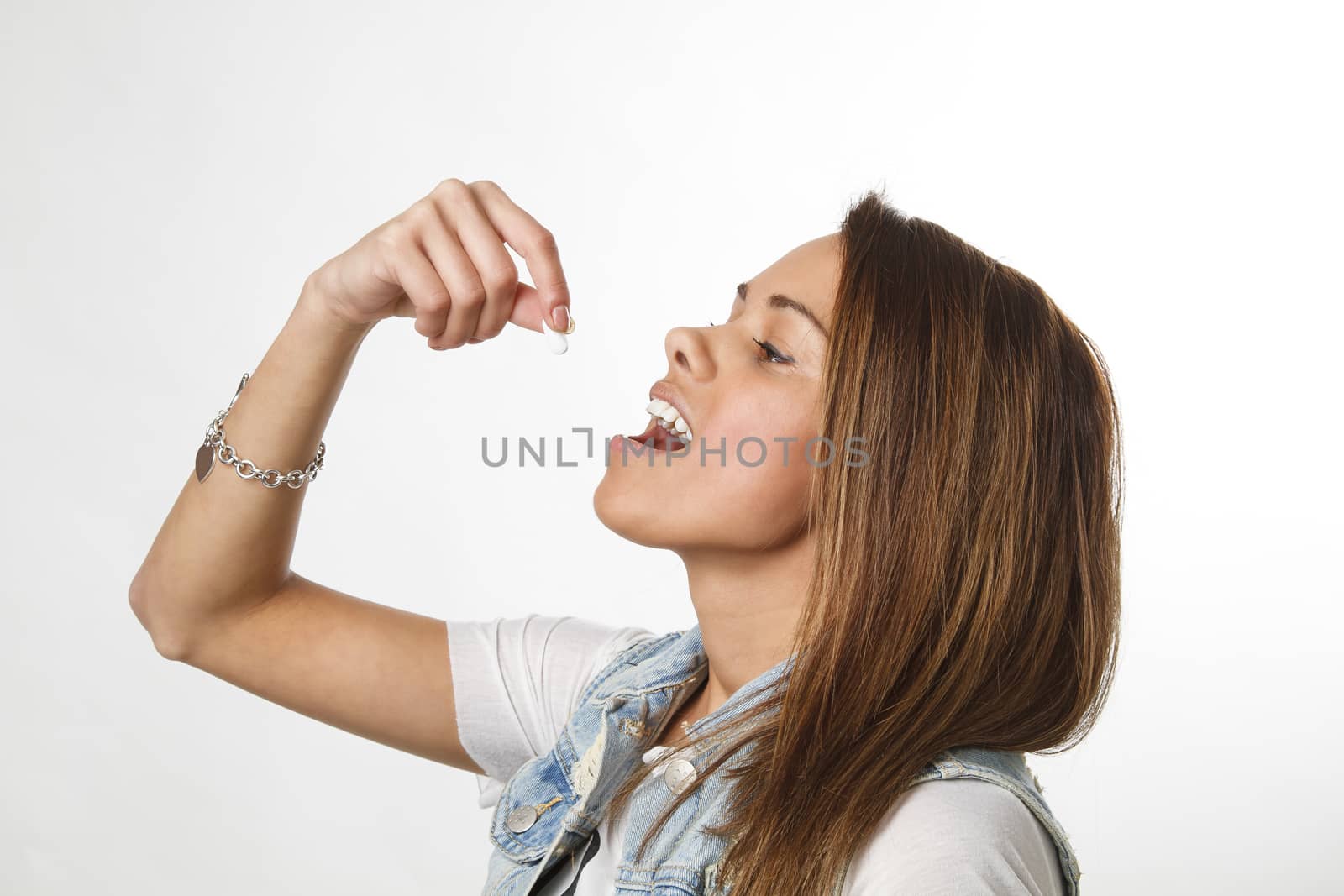 twenty something girl about to swallow a pill