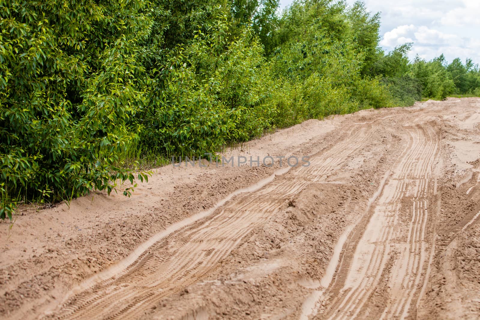 Off road 4X4 wheel tracks on country desert beach road sand motoring background image