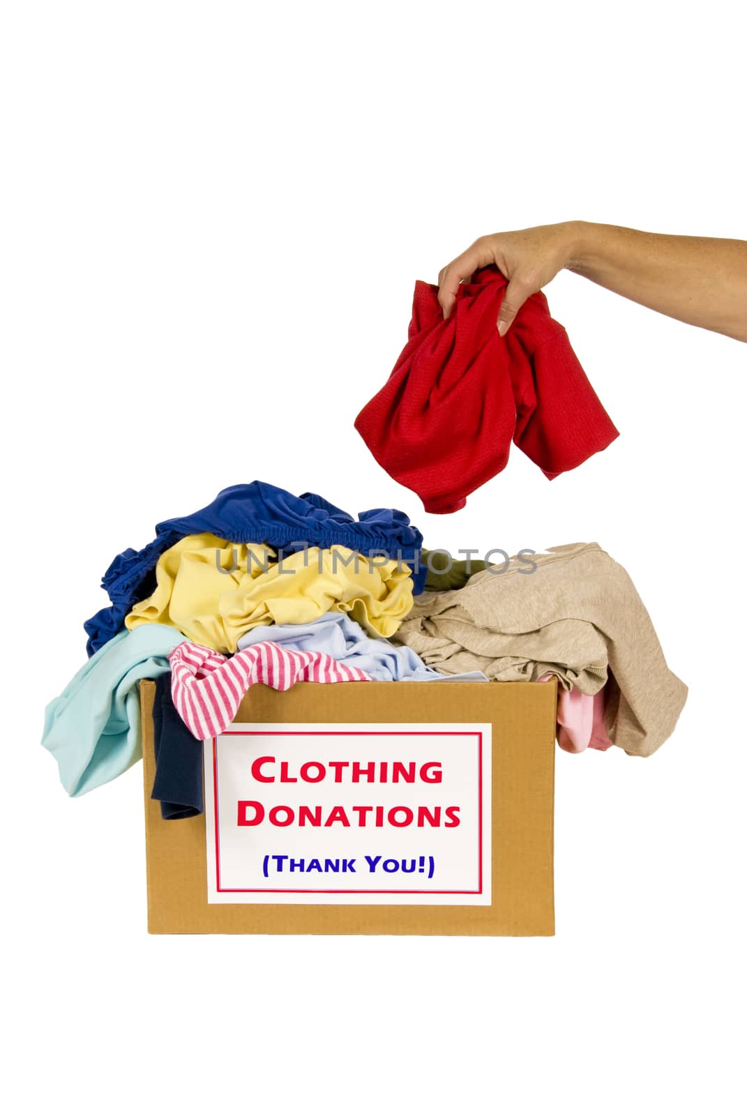 Woman's hand dropping clothes into a donation box. Isolated on white.