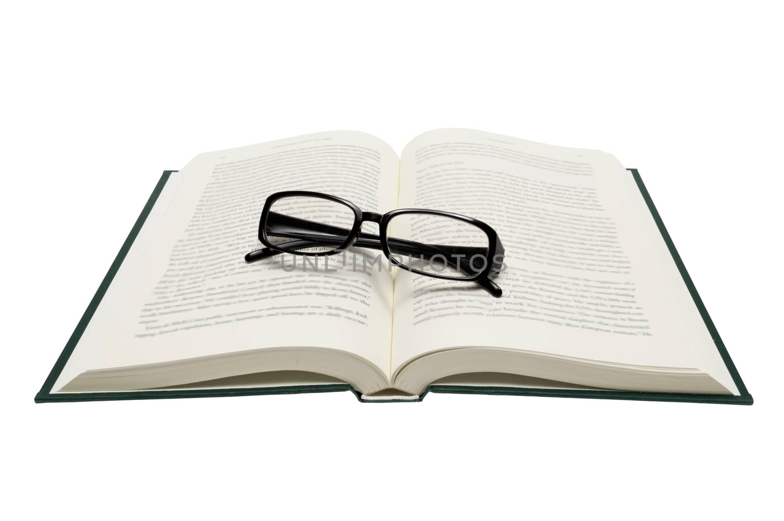 Horizontal shot of folded glasses on an opened book.  Isolated on white.