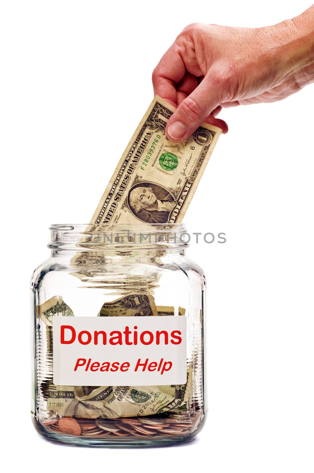 Hand putting money into Donations jar.