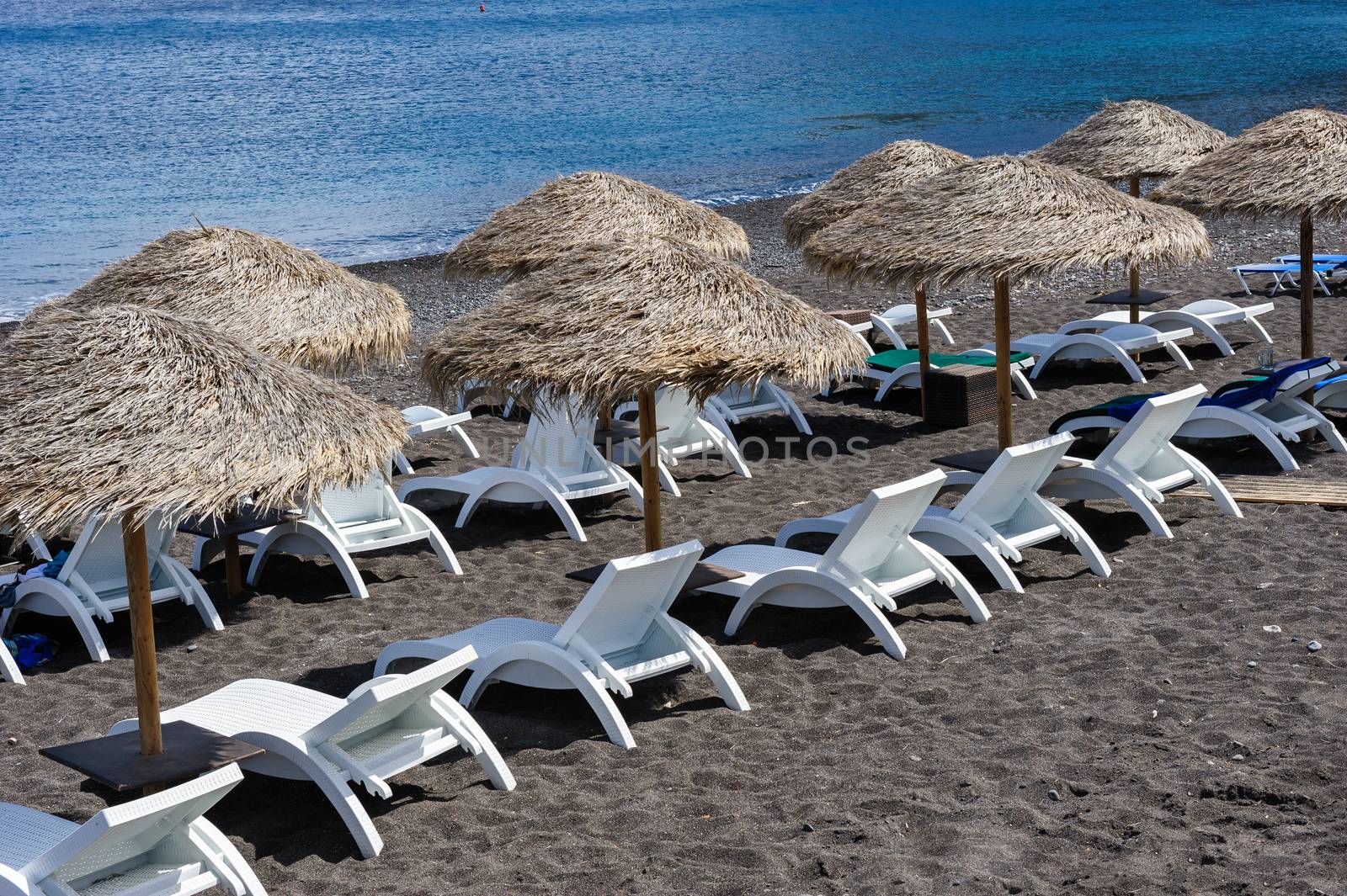 Cane umbrellas at Black Beach near Kamari, Santorini Greece