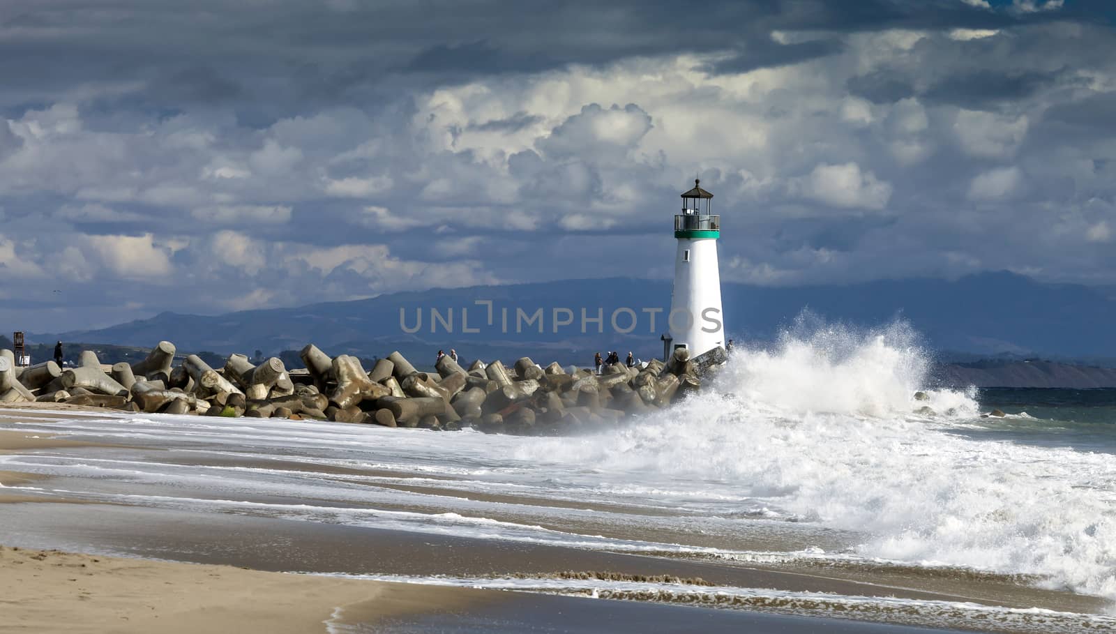 Santa Cruz, California, USA, November 1, 2014: Lighthouse Walton on Santa Cruz Shore with the surf and visitors. The lighthouse, designed by Mark Mesiti-Miller and constructed by Devcon Construction, Inc., stands 41 ½ feet tall above the level of the water.