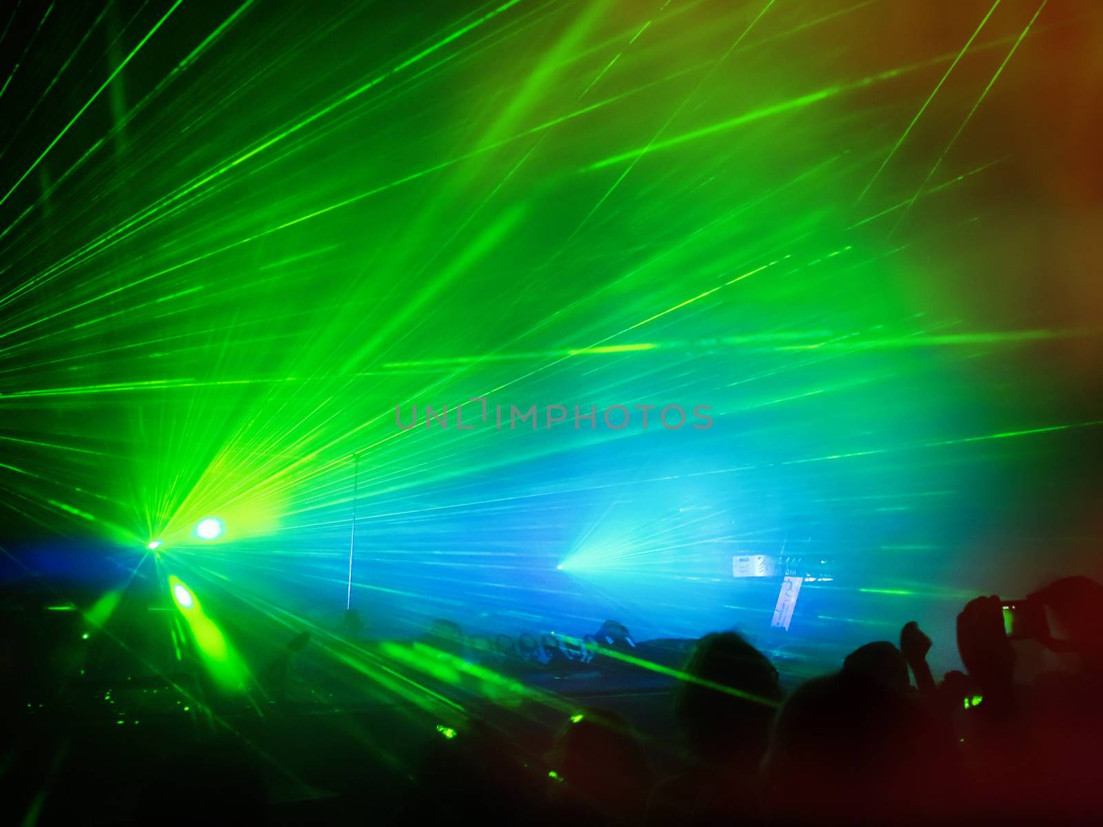 Visual effects at the concert created with lasers and smoke.