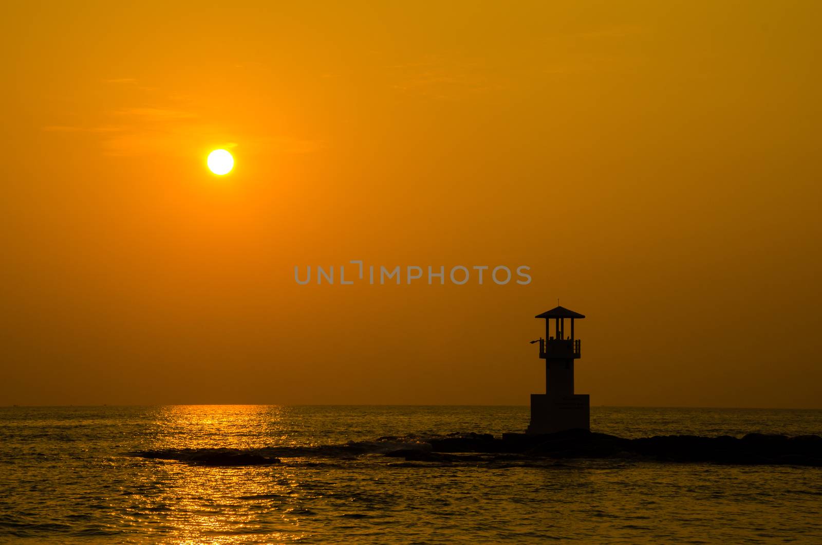 Silhouettes of lighthouse at ocean, Khao Lak beach, Phangnga Thailand.