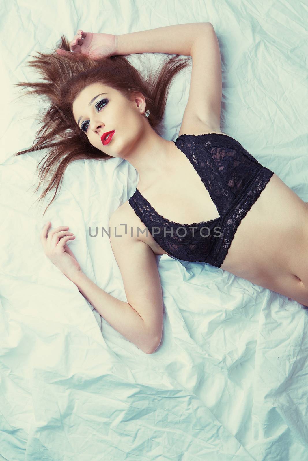 sexy attractive slim girl in bed, black bra