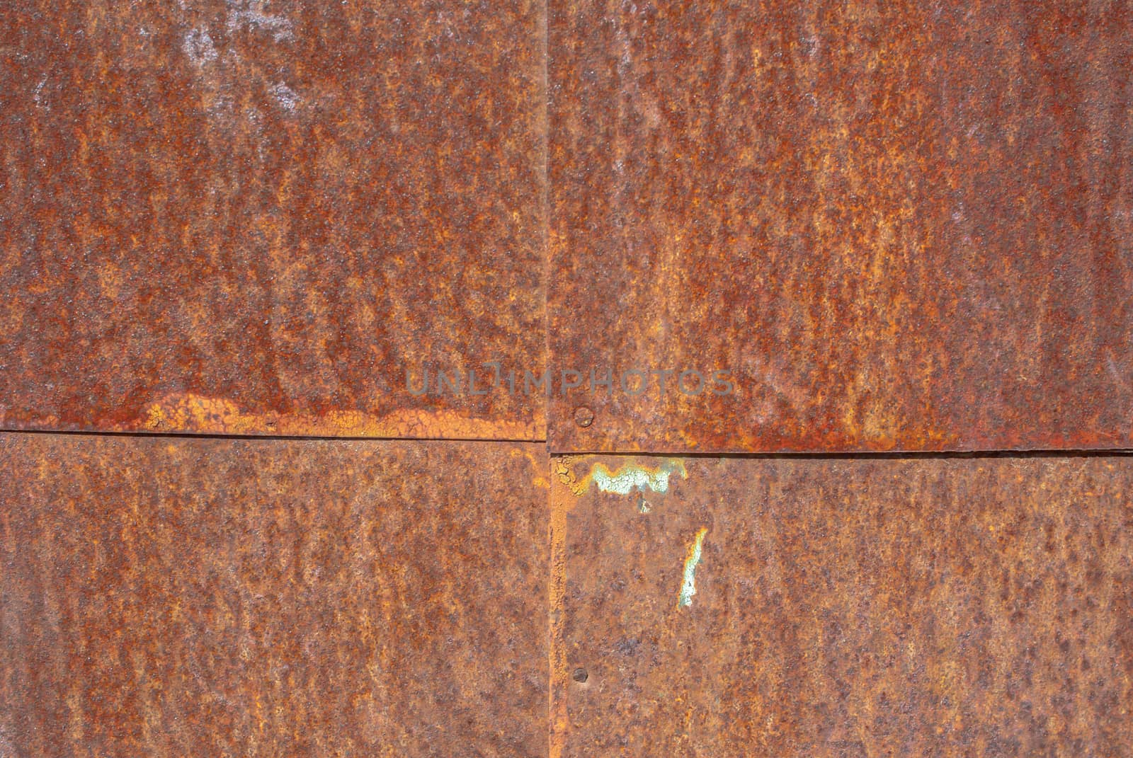 rusty iron surface covered with old chipped paint, which has long been influenced by different climatic conditions