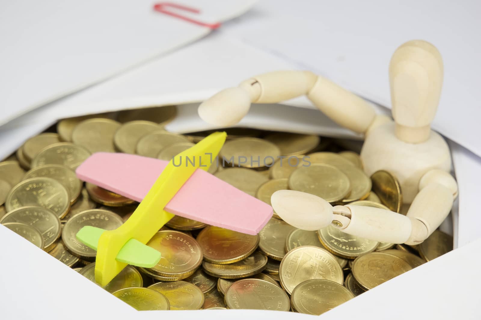 Airplane and wooden dummy surrounded by stack of gold coins by eaglesky