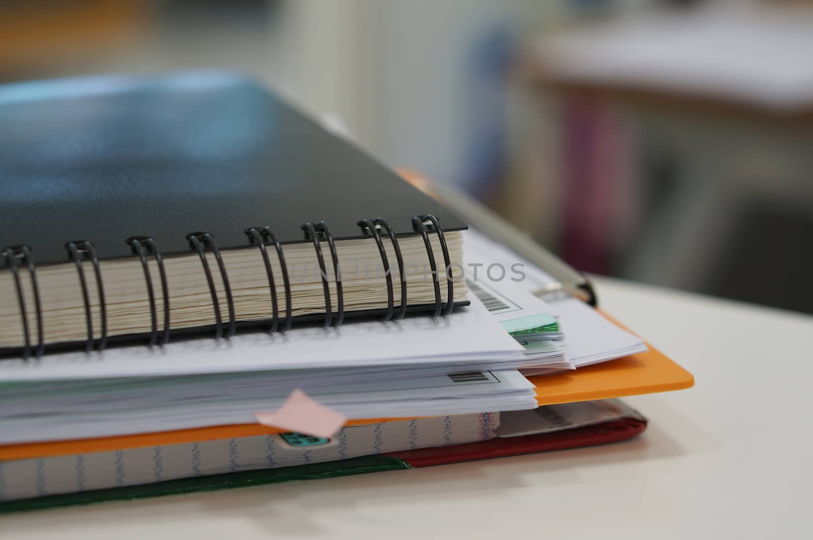 Stack of paperwork and black notebook by ninun