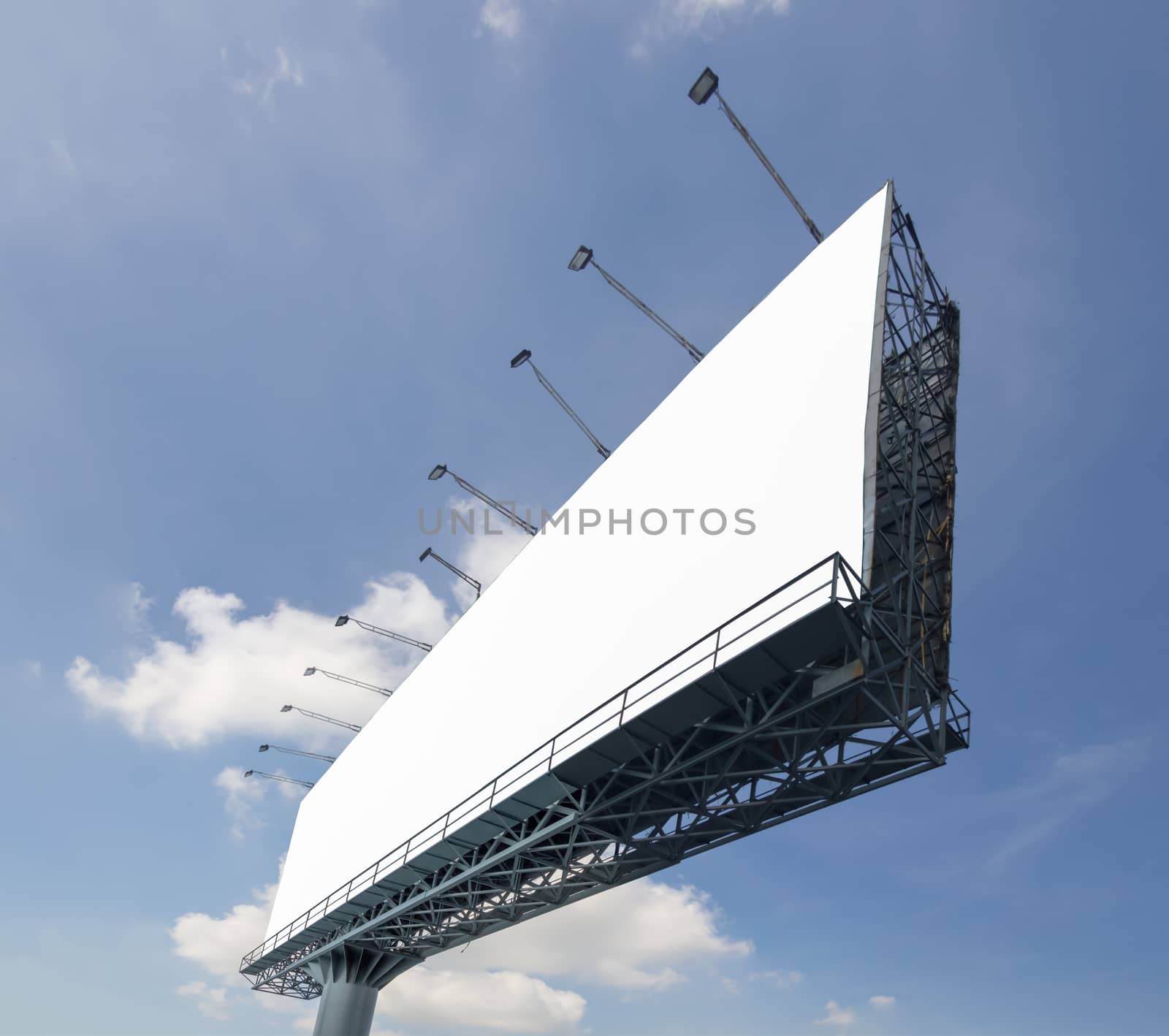 Blank billboard at a day on blue sky with cloud for advertisement