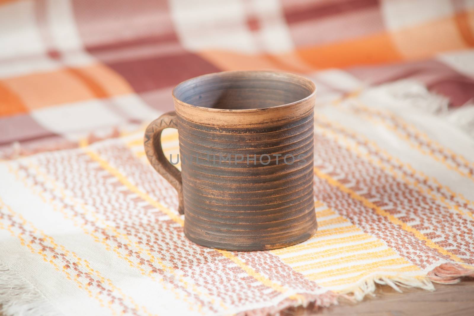 Traditional handcrafted mug on multycolor background. High resolution