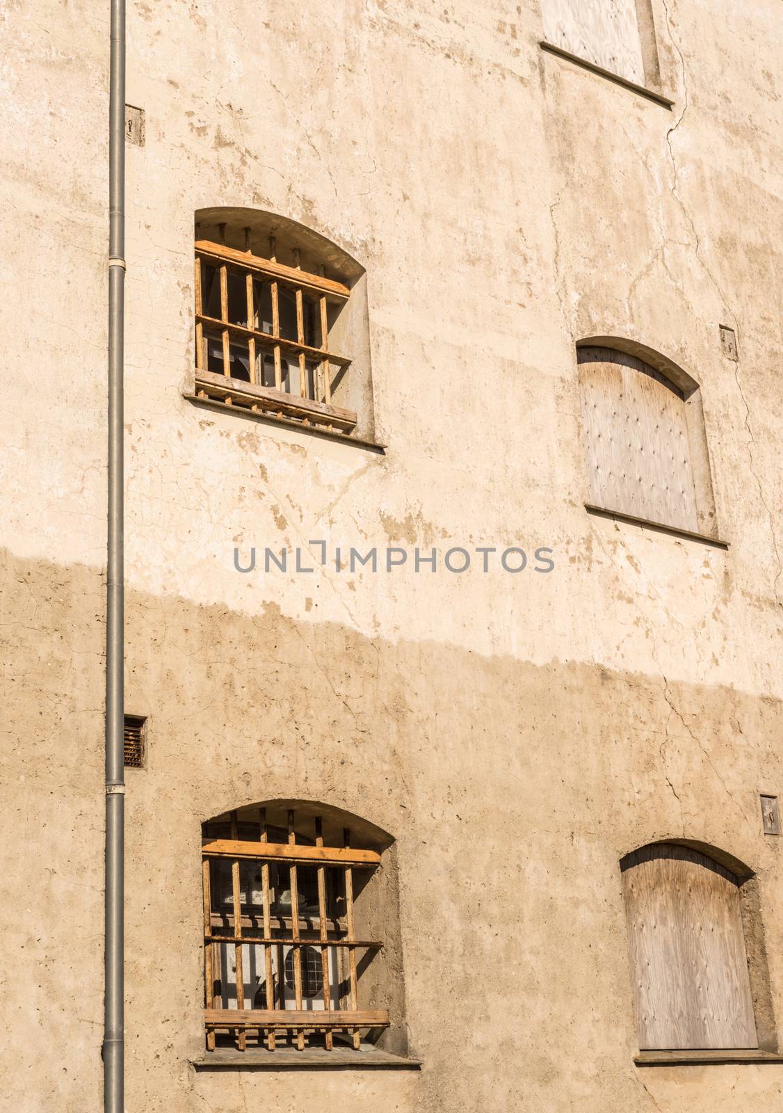 Bars on prison windows on a conrete wall
