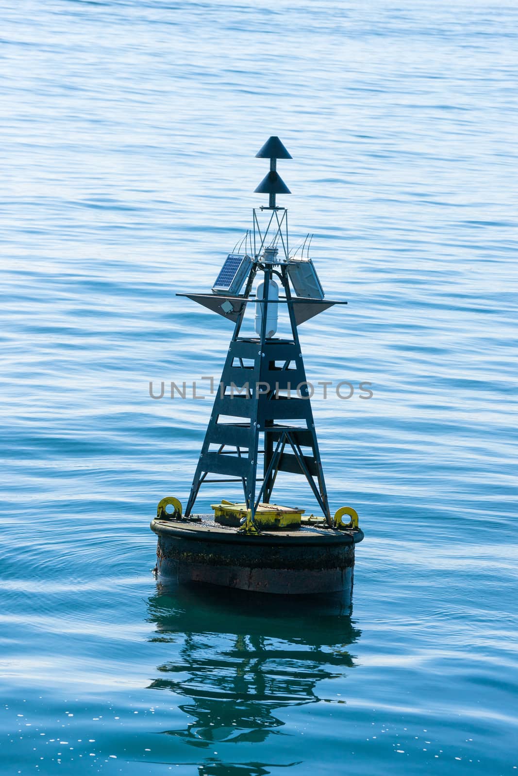 Close-up of a buoy in the blue sea by Sportactive