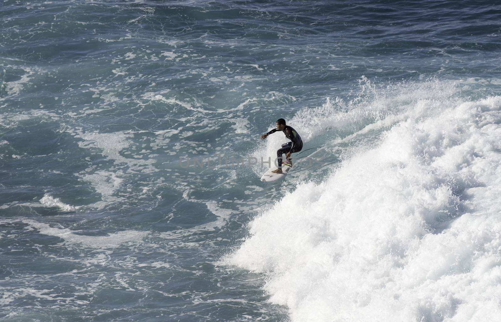 SAO VINCENTE,PORTUGAL-MARCH 24 Unidentified boy surfing on the big waves at the north coast of Madeira on MArch 23,2016 in Sao Vincente,Sao Vincente had the biggest waves at the portugal coast
