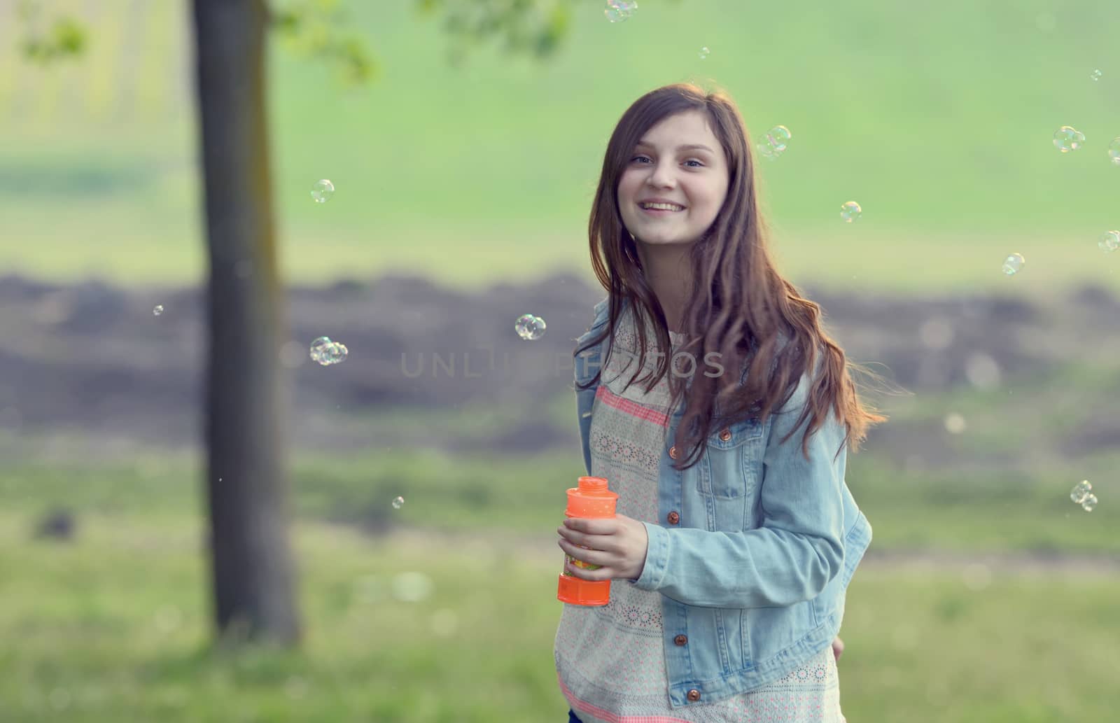 Young girl play with soap-bubbles by mady70