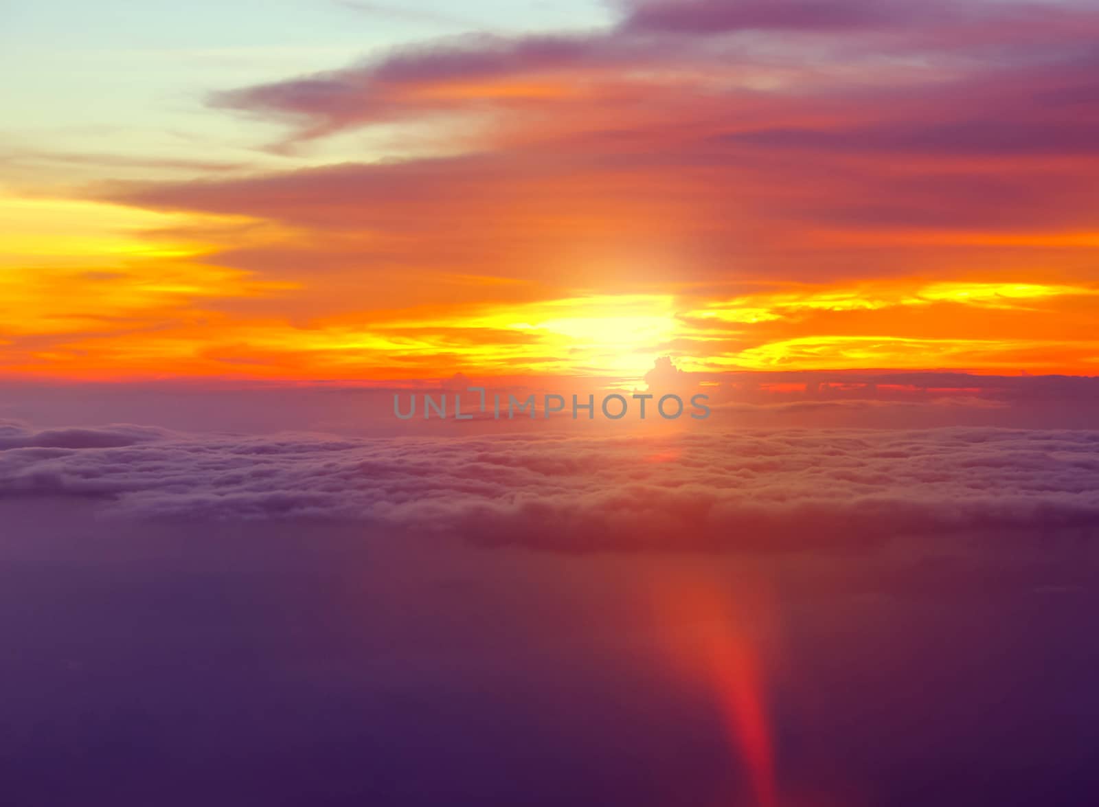 Sunset with clouds over view from airplane flying