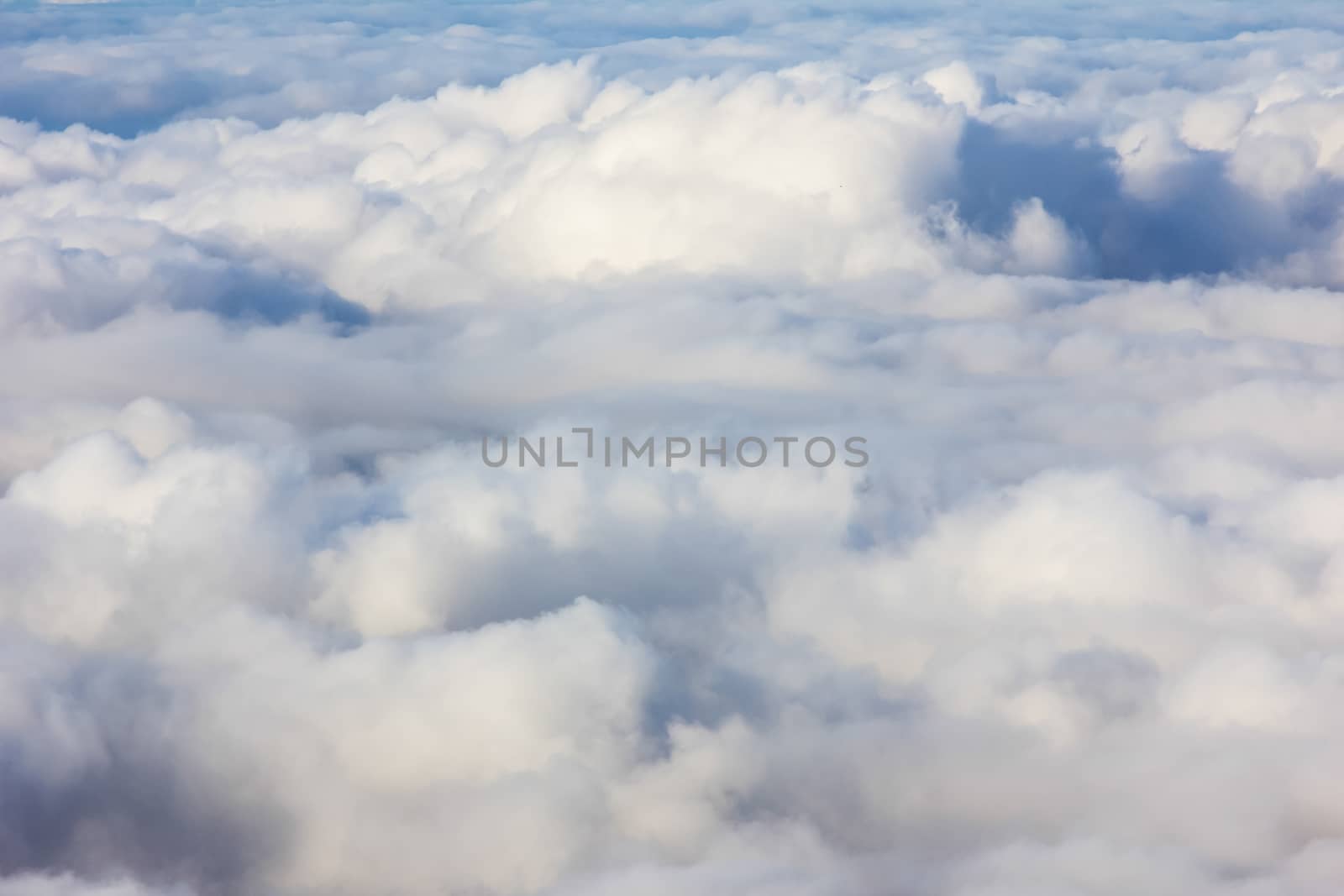 Soft clouds over view from airplane flying