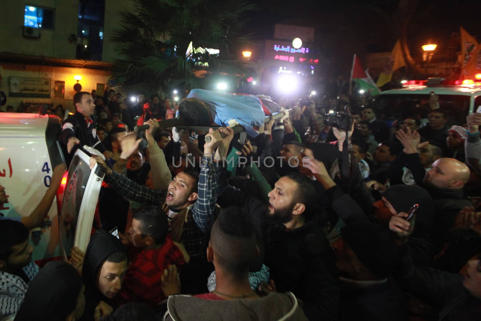 WEST BANK, Bethlehem : Palestinians carry the body of 16-year-old Mamoon Raed Muhammed al-Khatib,and the body of Essam Thawabteh,two young alleged Palestinians attackers whose bodies were held by Israeli forces, in Bethlehem on December 27, 2015. Since a wave of unrest swept the occupied Palestinian territory at the beginning of October 2015, Israel has routinely held the bodies of Palestinians it alleges were attempting to attack Israelis when they were killed. Israel turned over to the Palestinian Authority the bodies of seven alleged Palestinians attackers on December 26, 2015. 