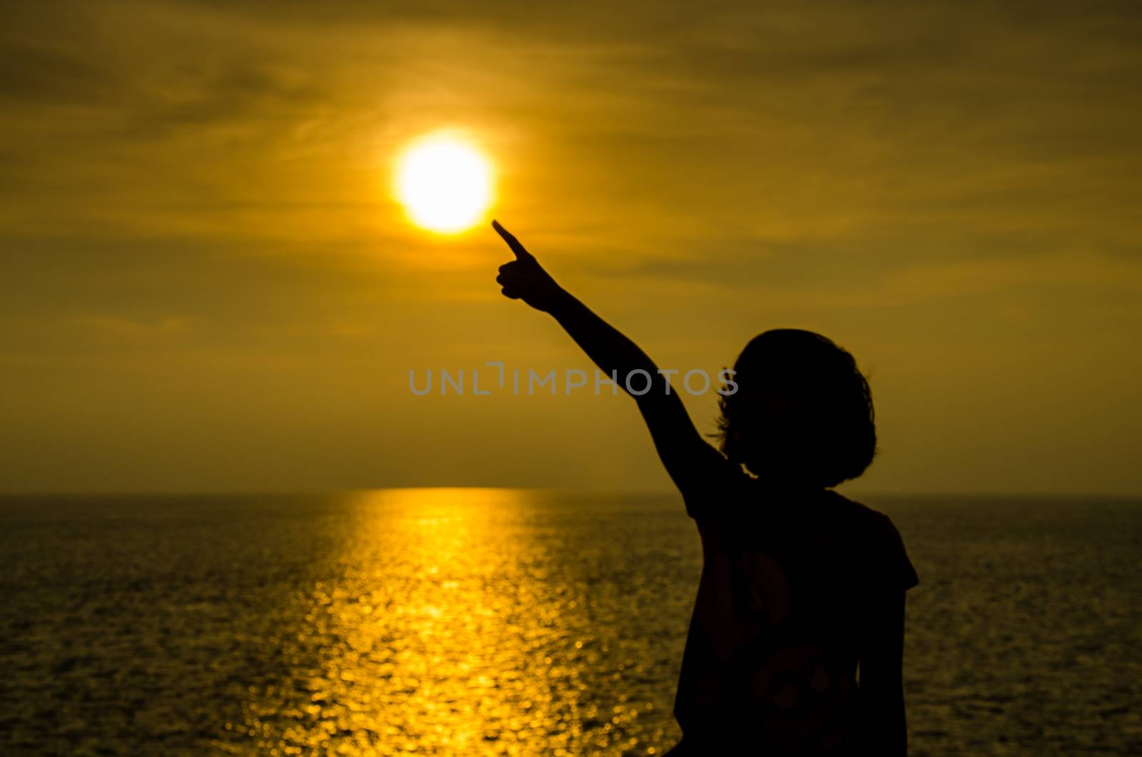 Silhouette of girl at sunset on ocean. concept hope