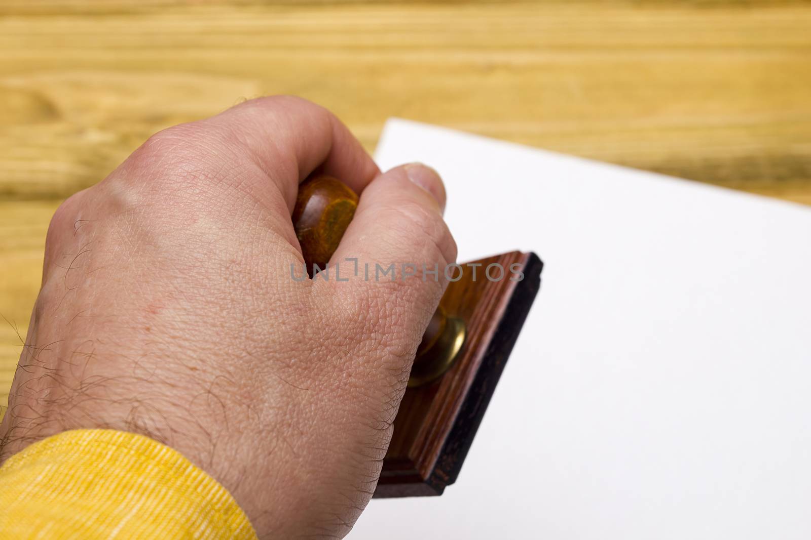 Wooden stamp in hand by VIPDesignUSA