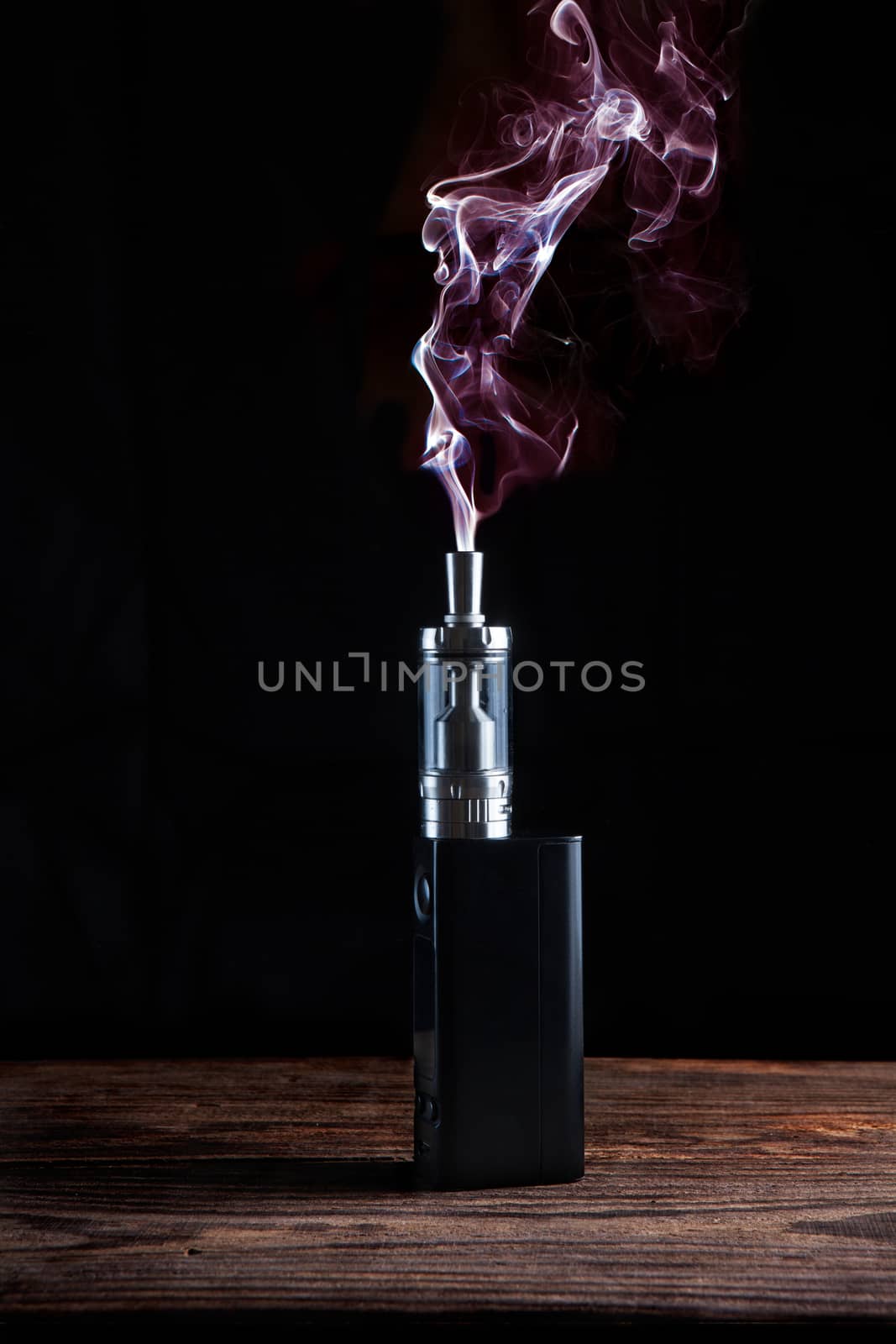 electronic cigarette over a dark background by fotoru