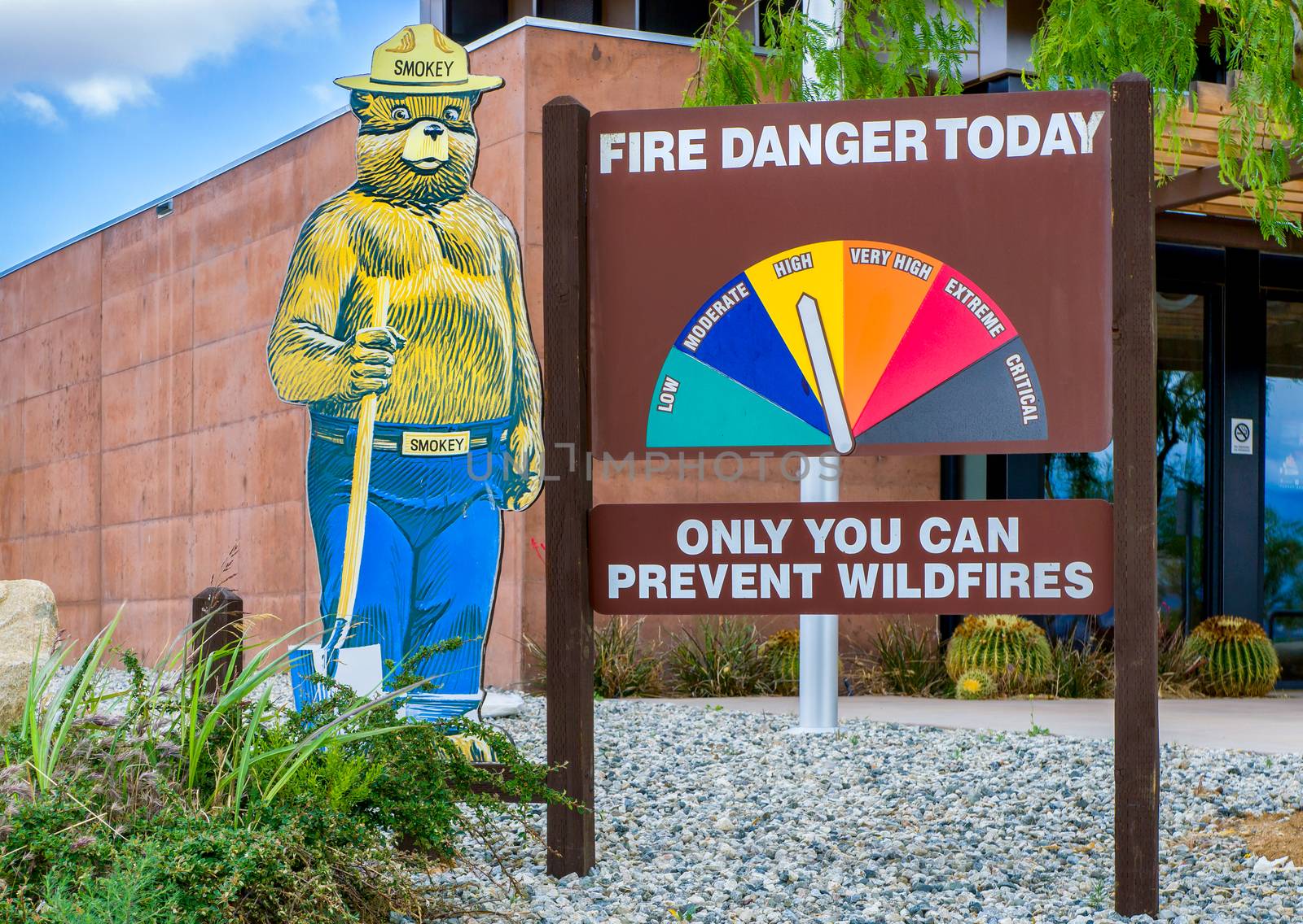 ACTON, CA/USA - MAY 7, 2016: Smokey Bear mascot and fire danger sign. Smokey the Bear is an advertising mascot to educate the public about forest fires.