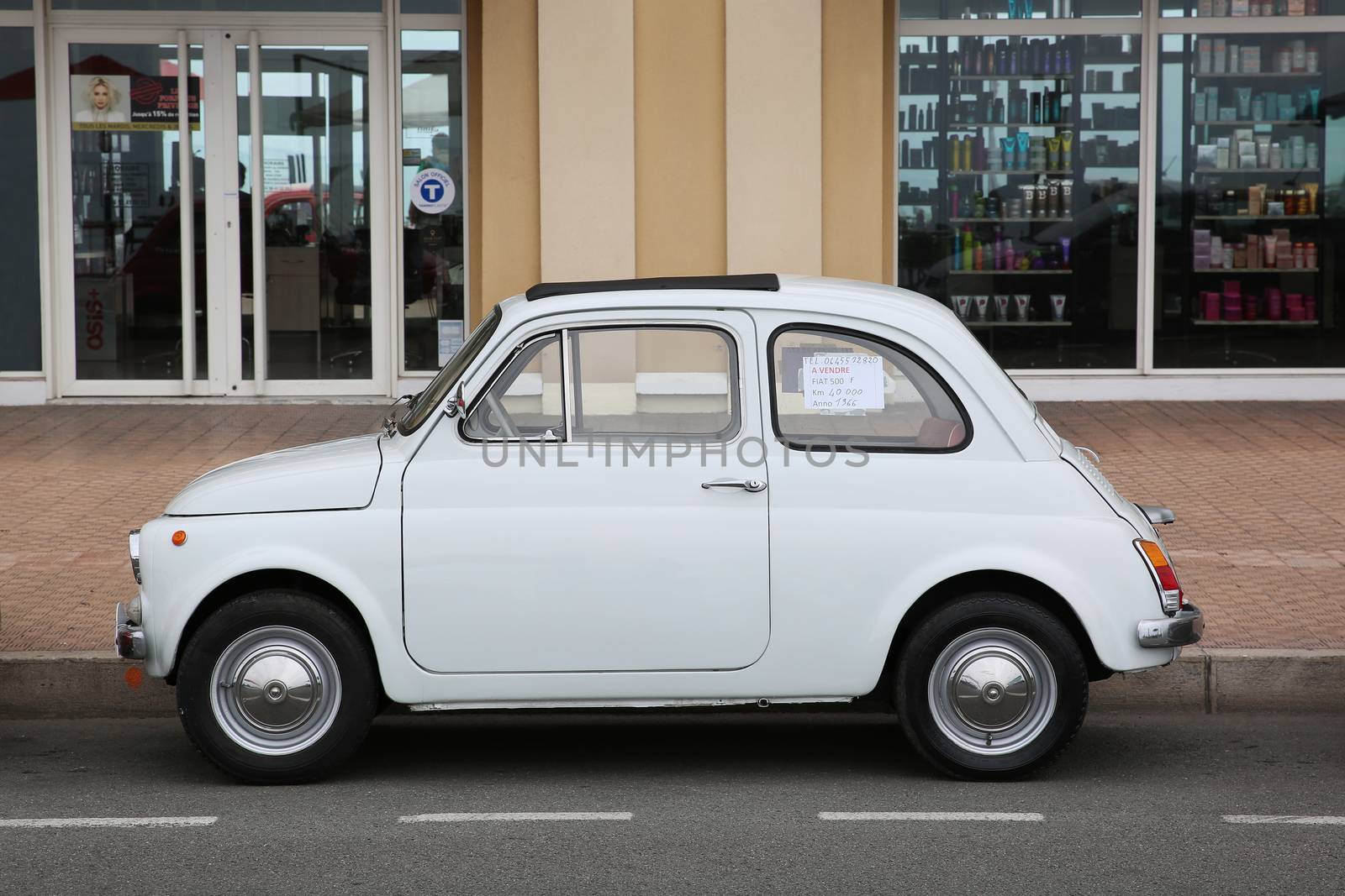 Menton, France - May 14, 2016: Small Italian car Fiat 500 Parked in a Parking Lot in Menton. Red Fiat 500 F