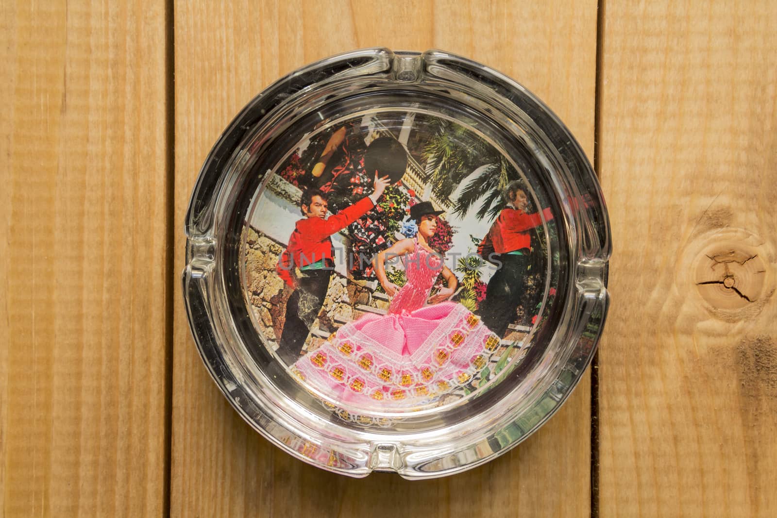 picture of Spanish dance in a glass ashtray on wooden background