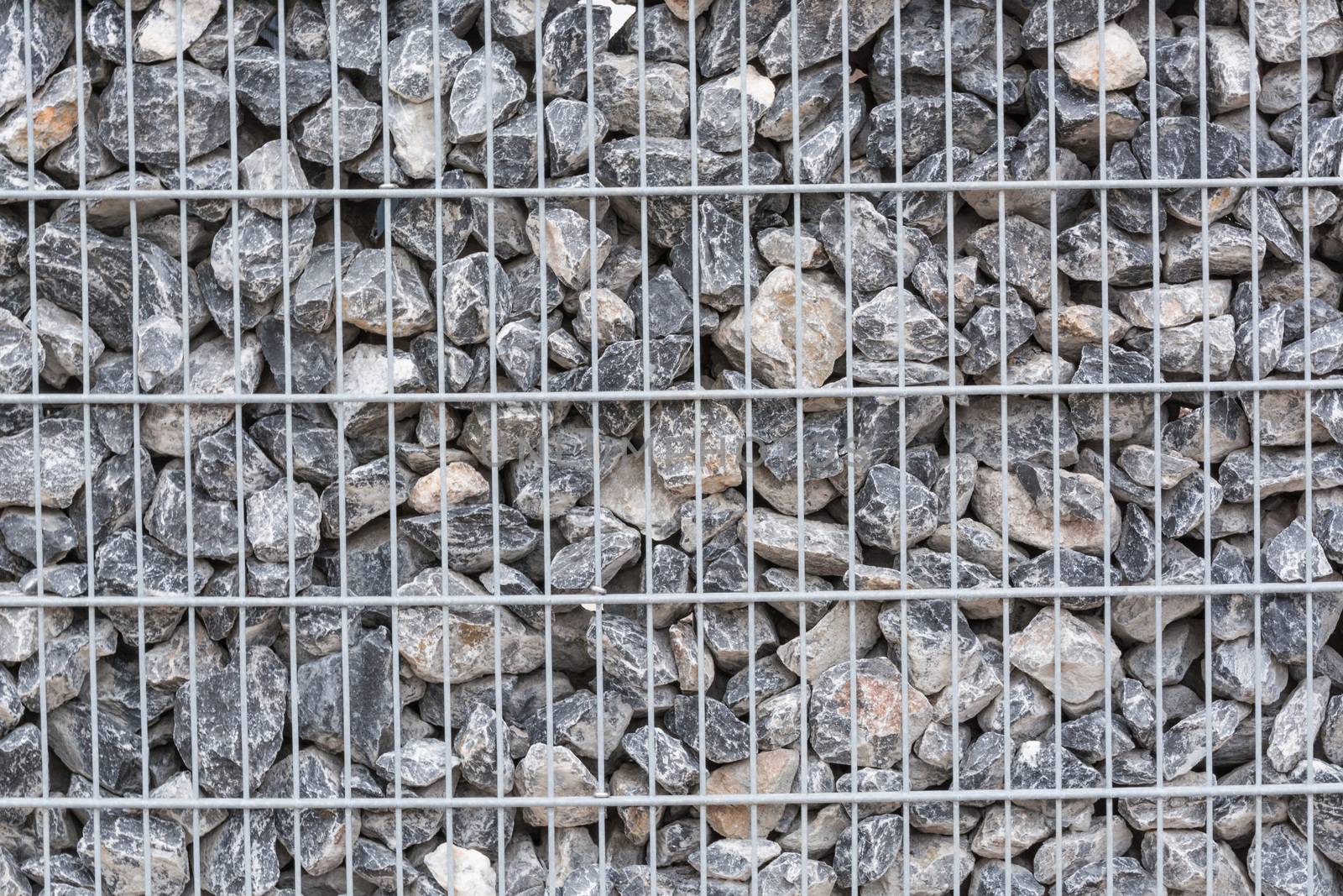 Gabion filled with thick stones; Metal Stone basket with large natural stones for external landscaping.