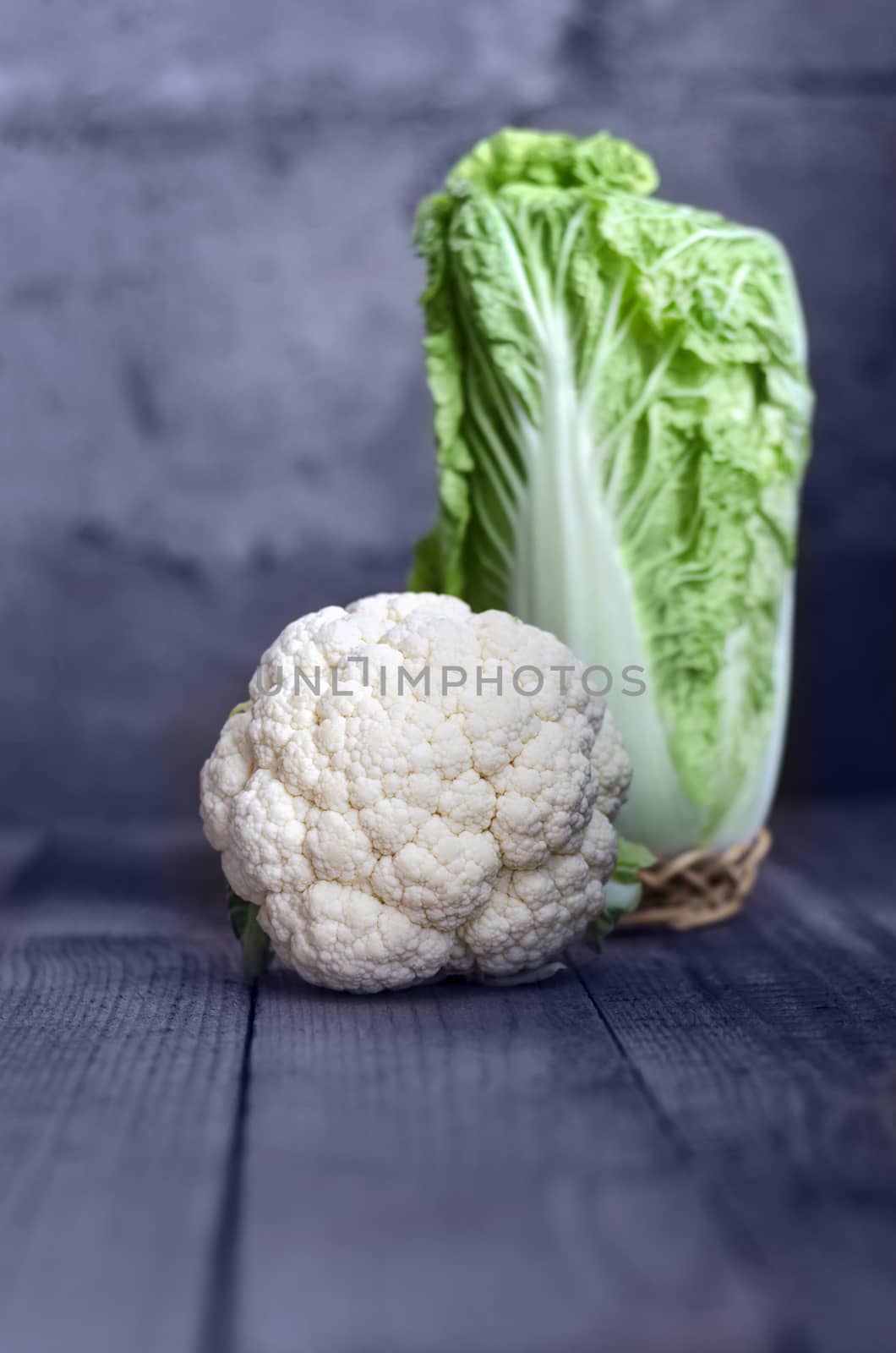 Cauliflower and cabbage on the old Board in a rustic style, bokeh