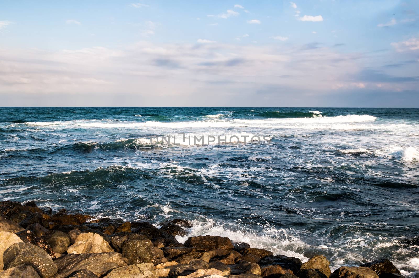 Seascape with clouds and rocks