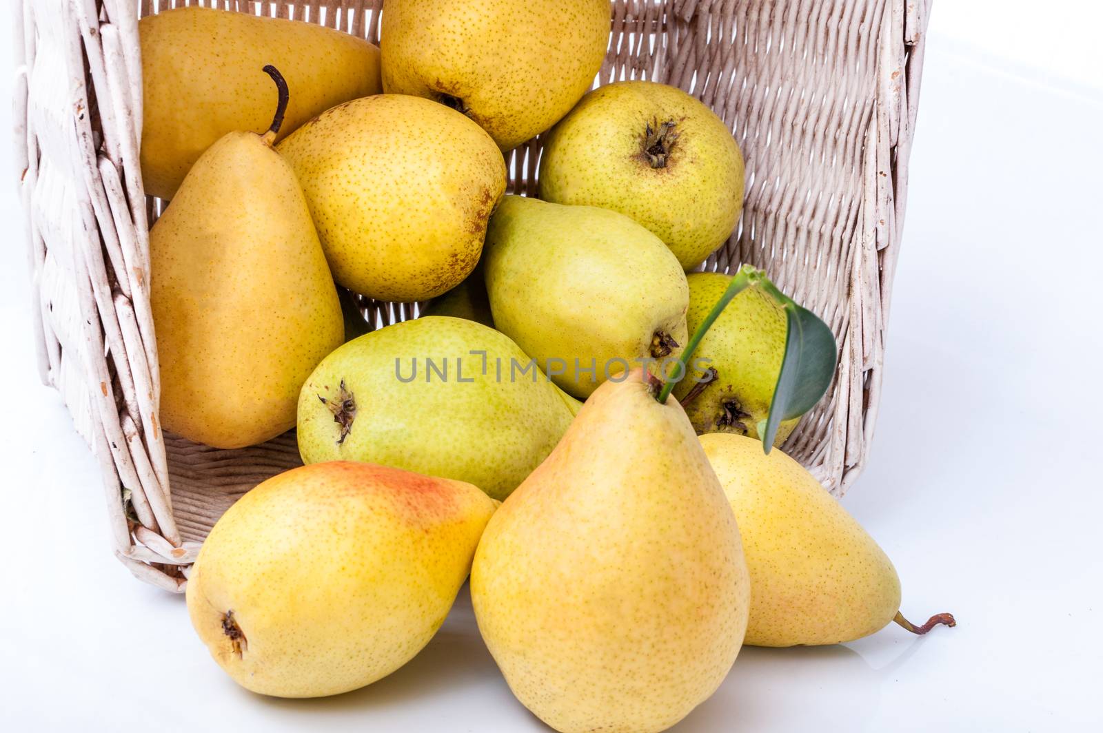 Ripe pears in a basket isolated on white background by mitakag