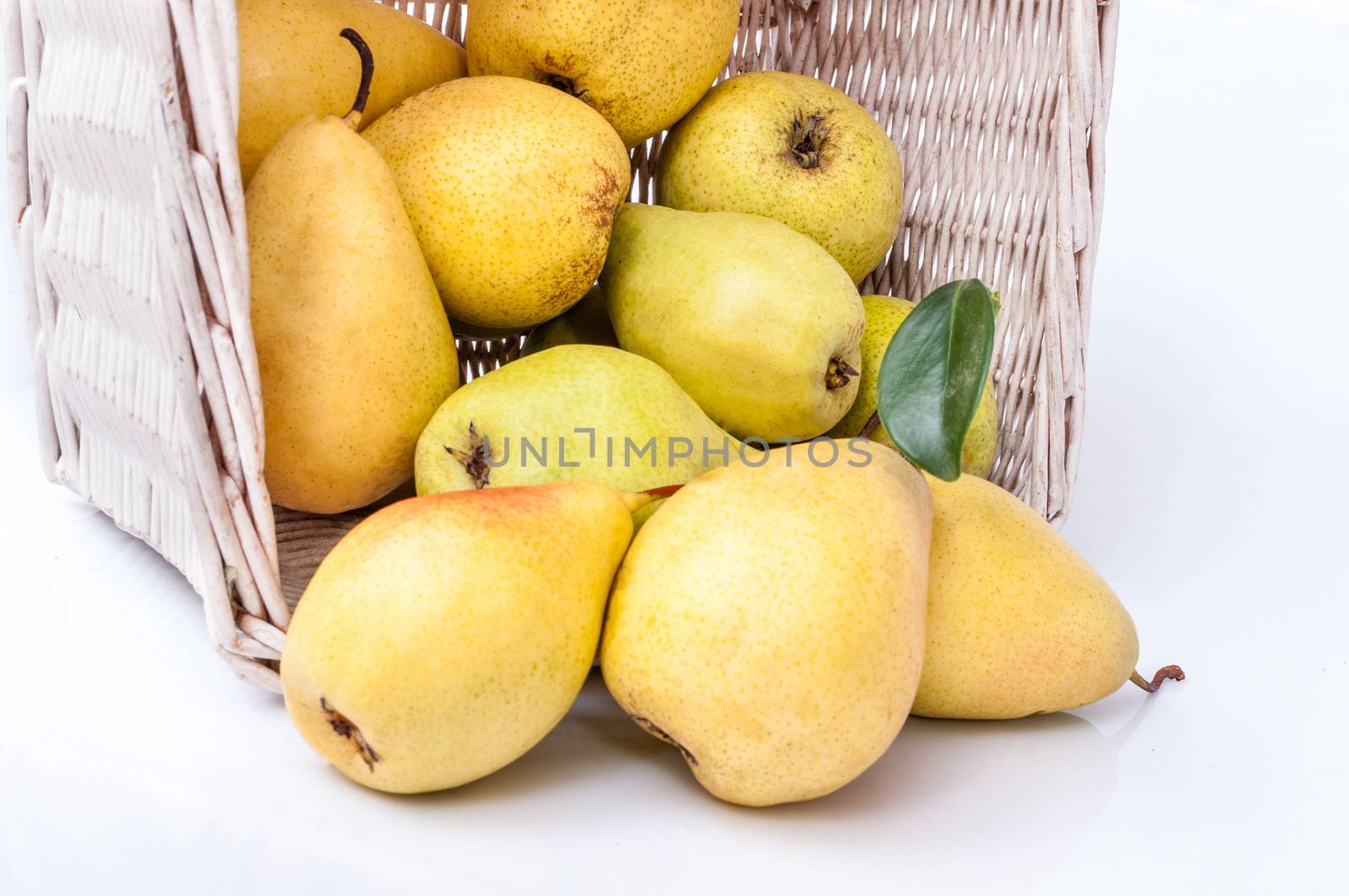 Yellow pears in a basket isolated on white background