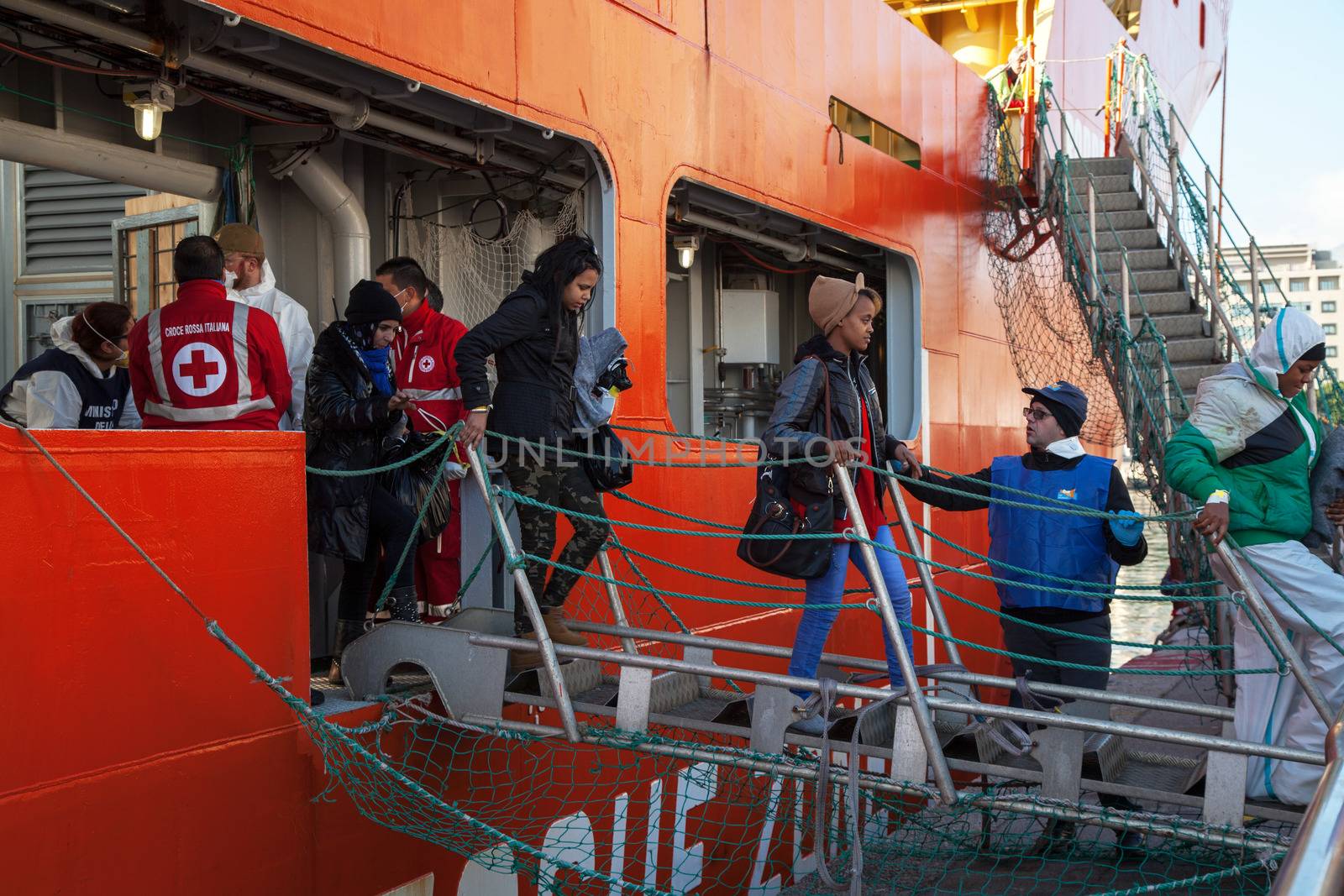 ITALY, Palermo: Migrants are seen disembarking from the military Norwegian ship Siem Pilot in Palermo on December 28, 2015. Among them 841 men, 64 women, and 26 children came from 30 different nationalities including Morocco and other Subsaharian countries. The Norwegian vessel has already rescued over 11,500 people from the Mediterranean since June.