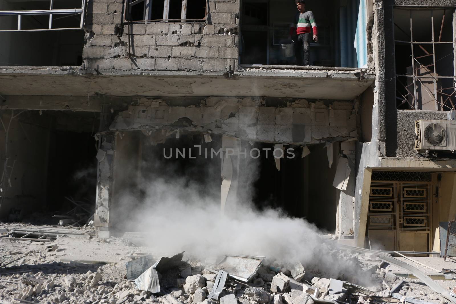 SYRIA, Saqba : A resident of the city of Saqba cleans a destroyed building of the city of East suburb of Damascus, the capital city of Syria, on December 28, 2015. Regime forces fired rockets on the towns of Douma, Harasta, Saqba and Arbin in the opposition-held Eastern Ghouta region on December 13, 2015 according to the Syrian Observatory for Human Rights. At least 45 people were killed during these attacks, according to the NGO. 
