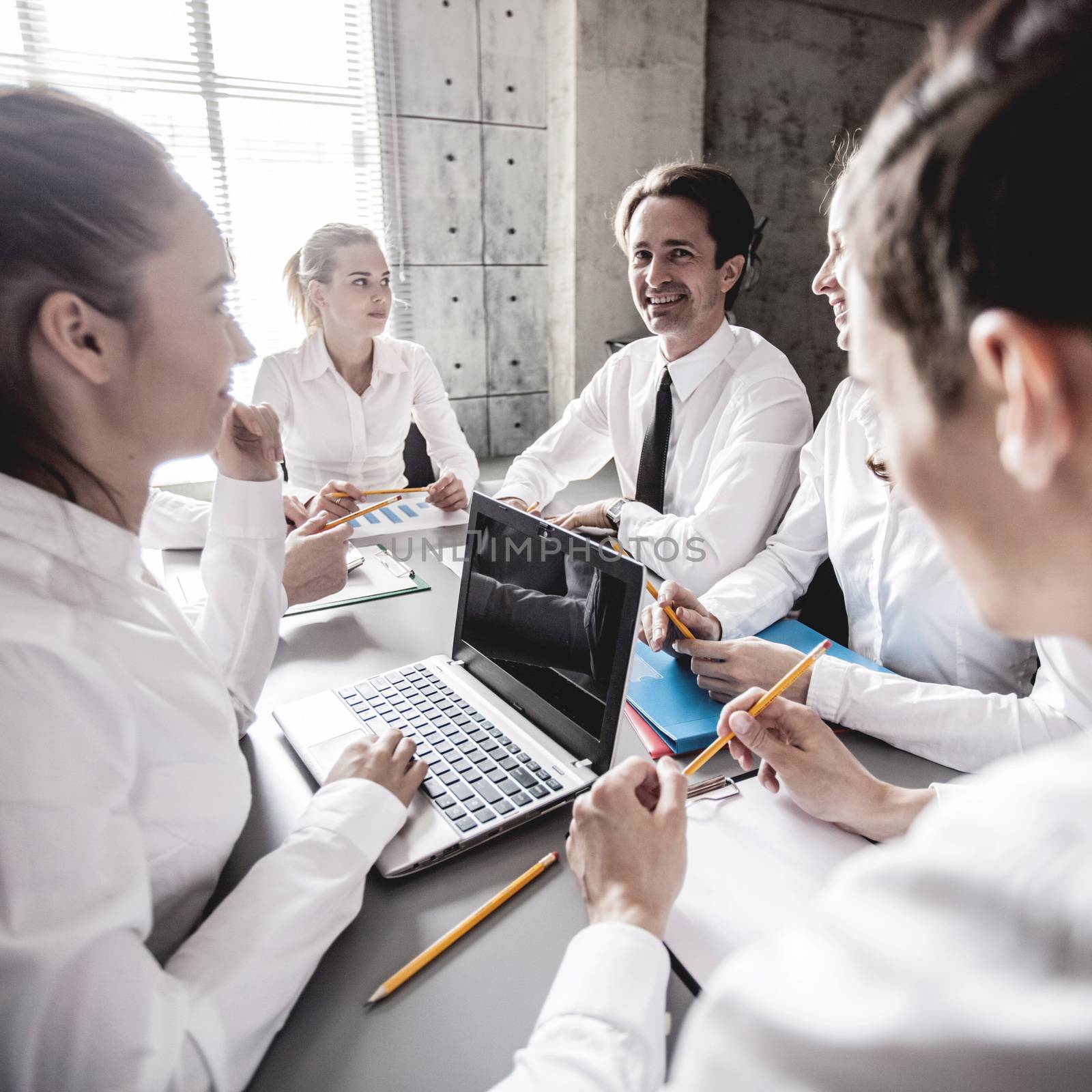 Group of business people working together at meeting in office