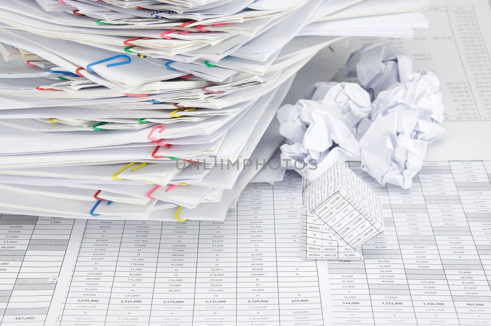 Bankruptcy of house on finance account have blur paper ball and overload document of report and receipt with colorful paperclip place confused as background.