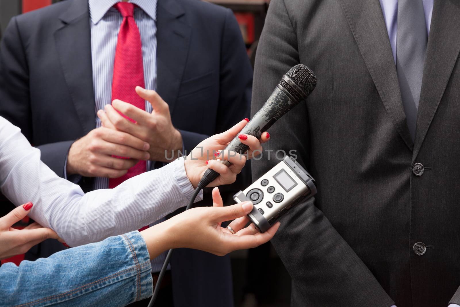 Journalists making interview with businessperson or politician