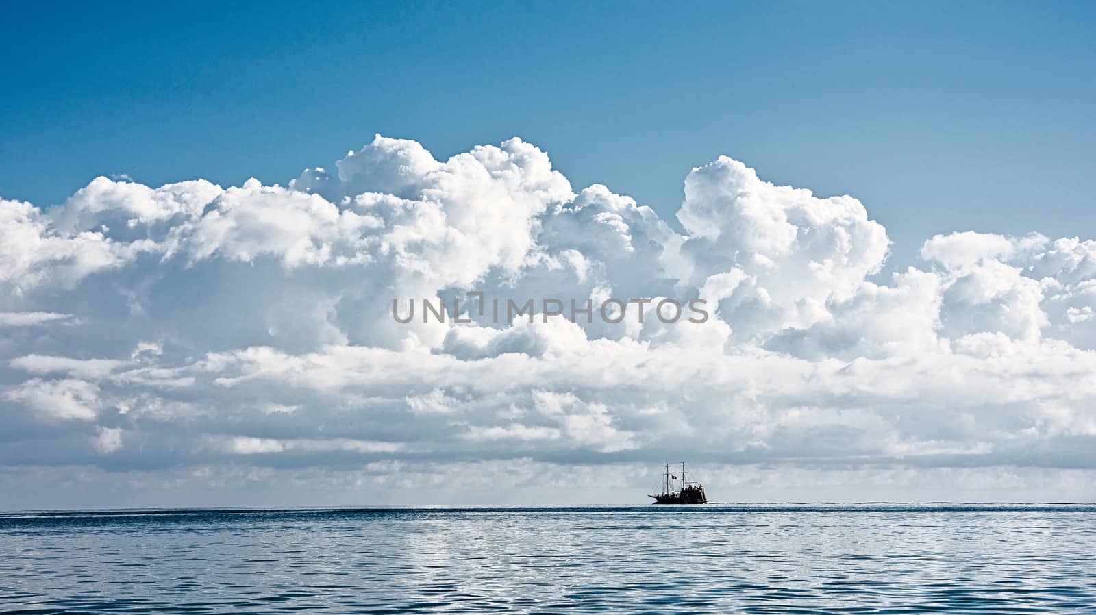 Seascape: ship on the horizon and the cumulus clouds by Grommik