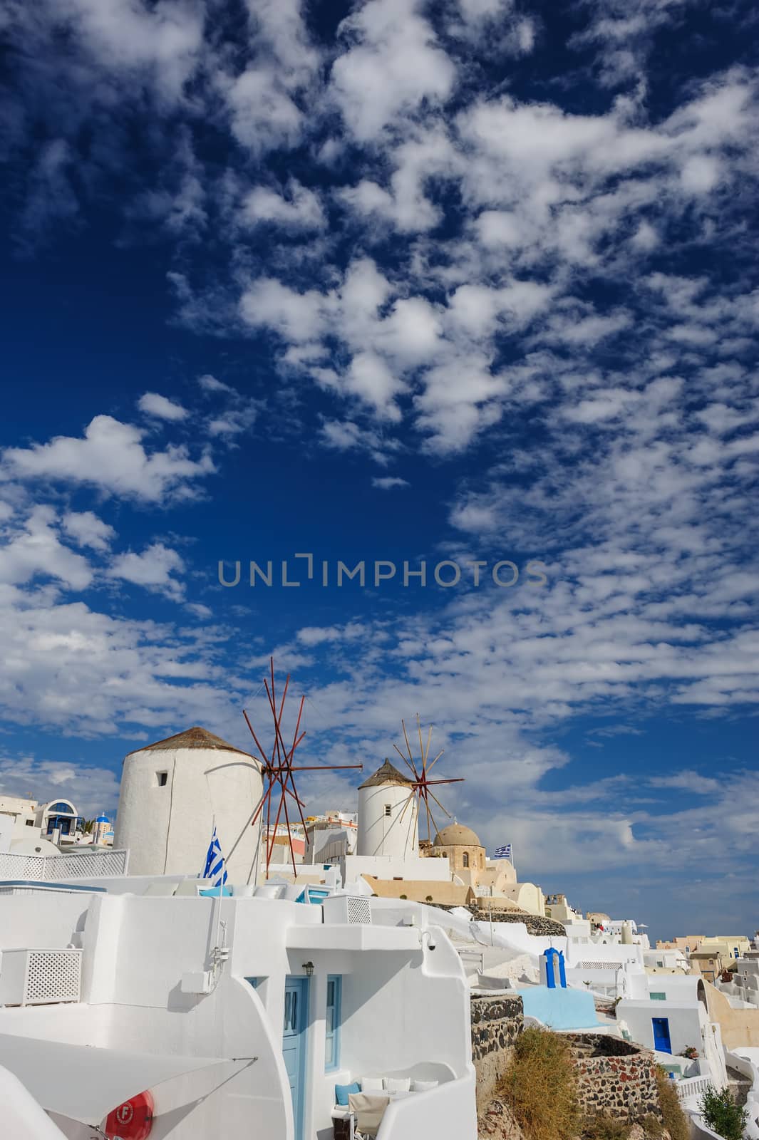 View of famous windmill in Oia village at Santorini Island, Greece. Copyspace.