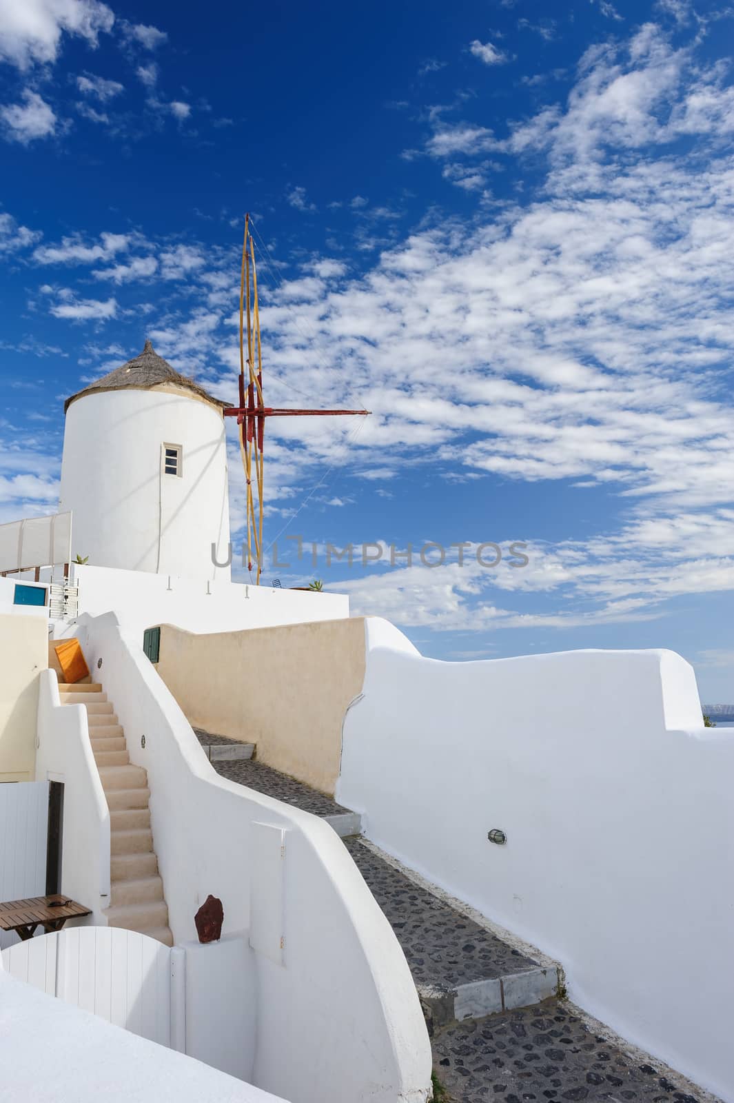 View of famous windmill in Oia village at Santorini Island, Greece. Copyspace.