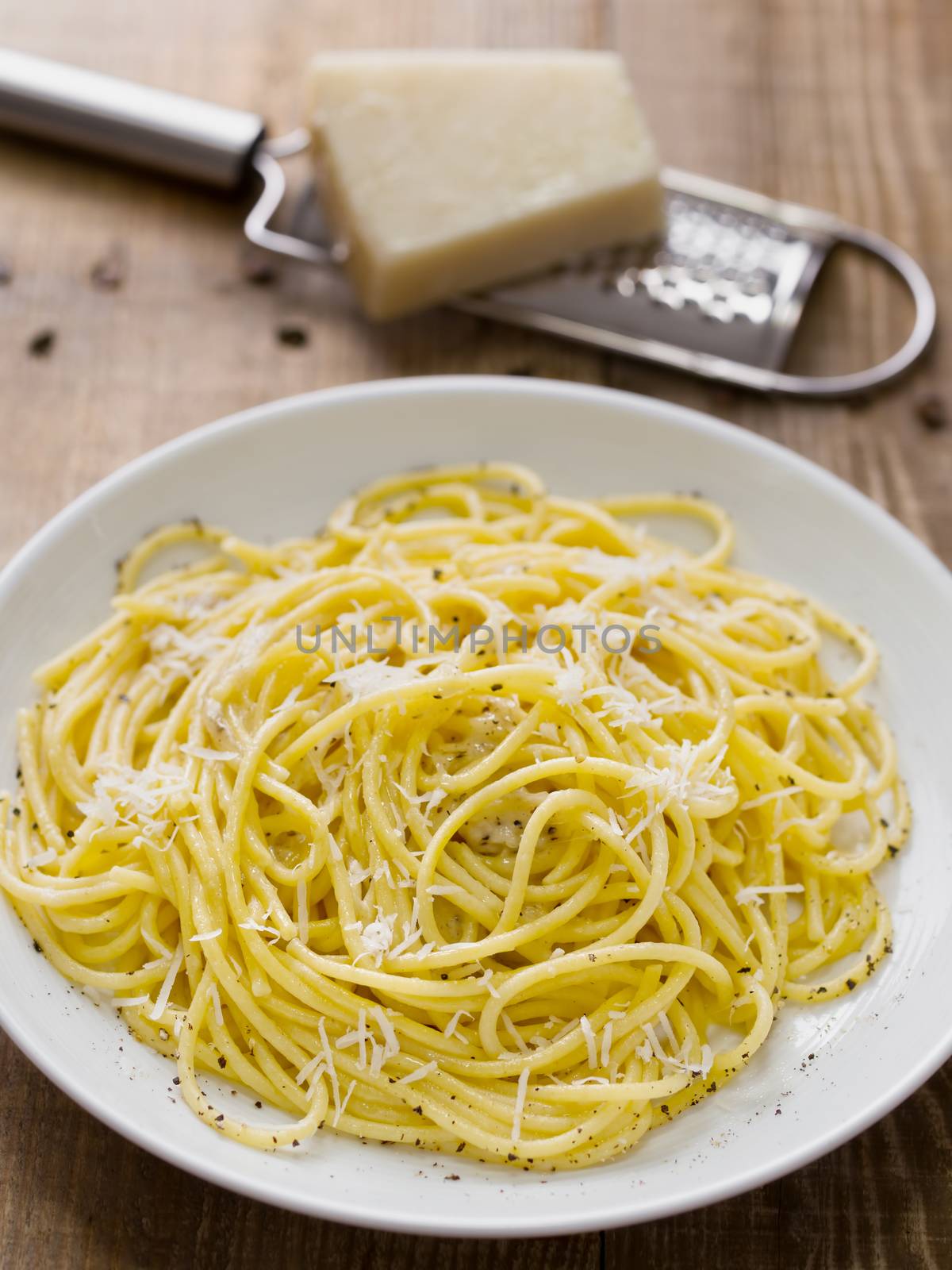 close up of rustic italian pepe e cacio pepper with cheese spaghetti